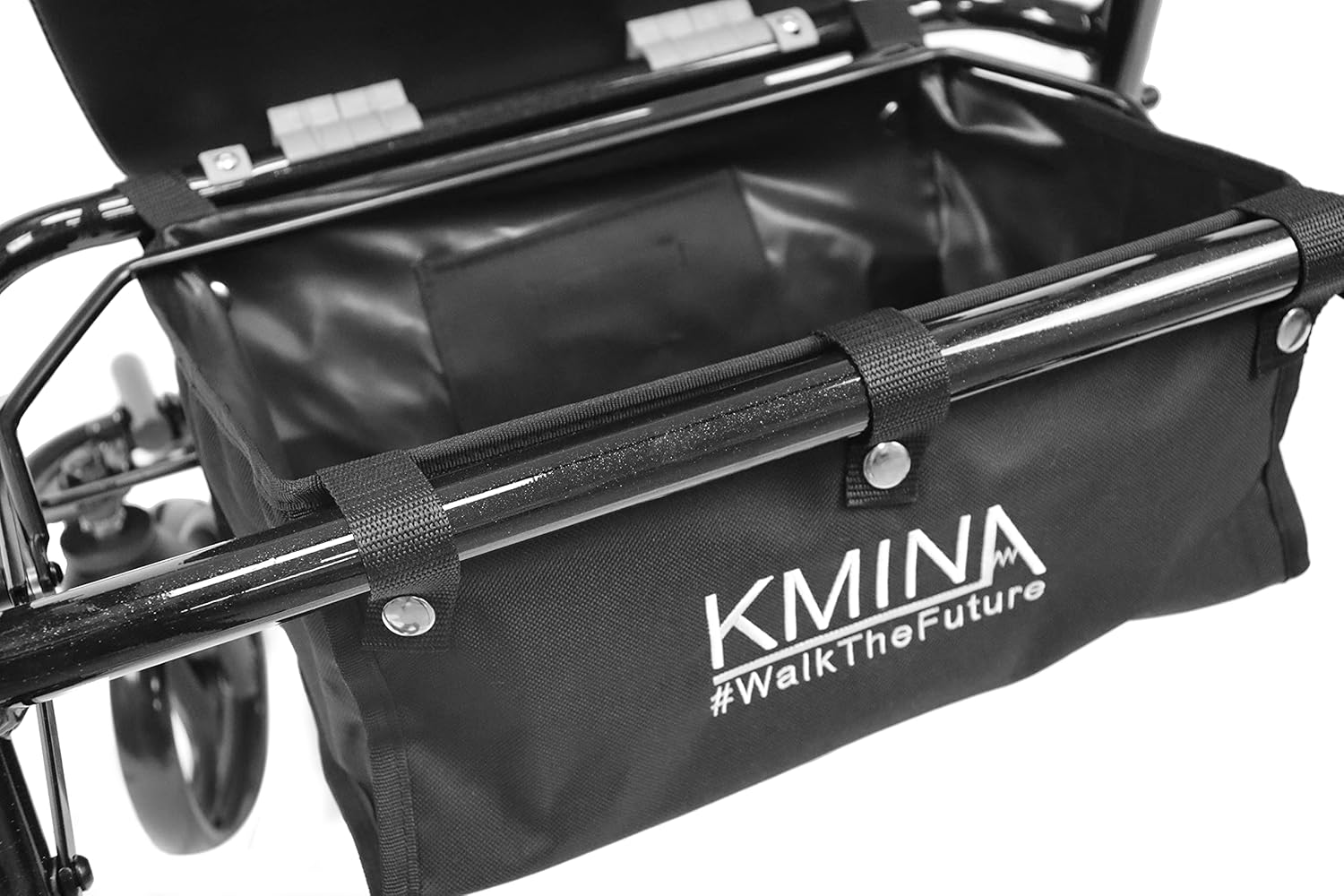 A person being pushed in the KMINA Rollator Wheelchair Combo in transport chair mode, with footrests deployed.