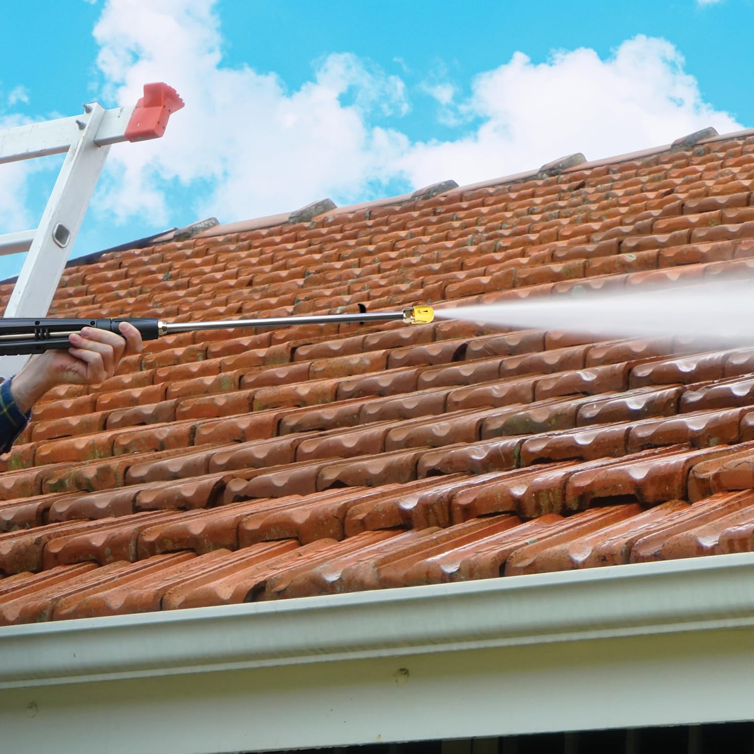 Pressure washer being used to clean a tiled roof