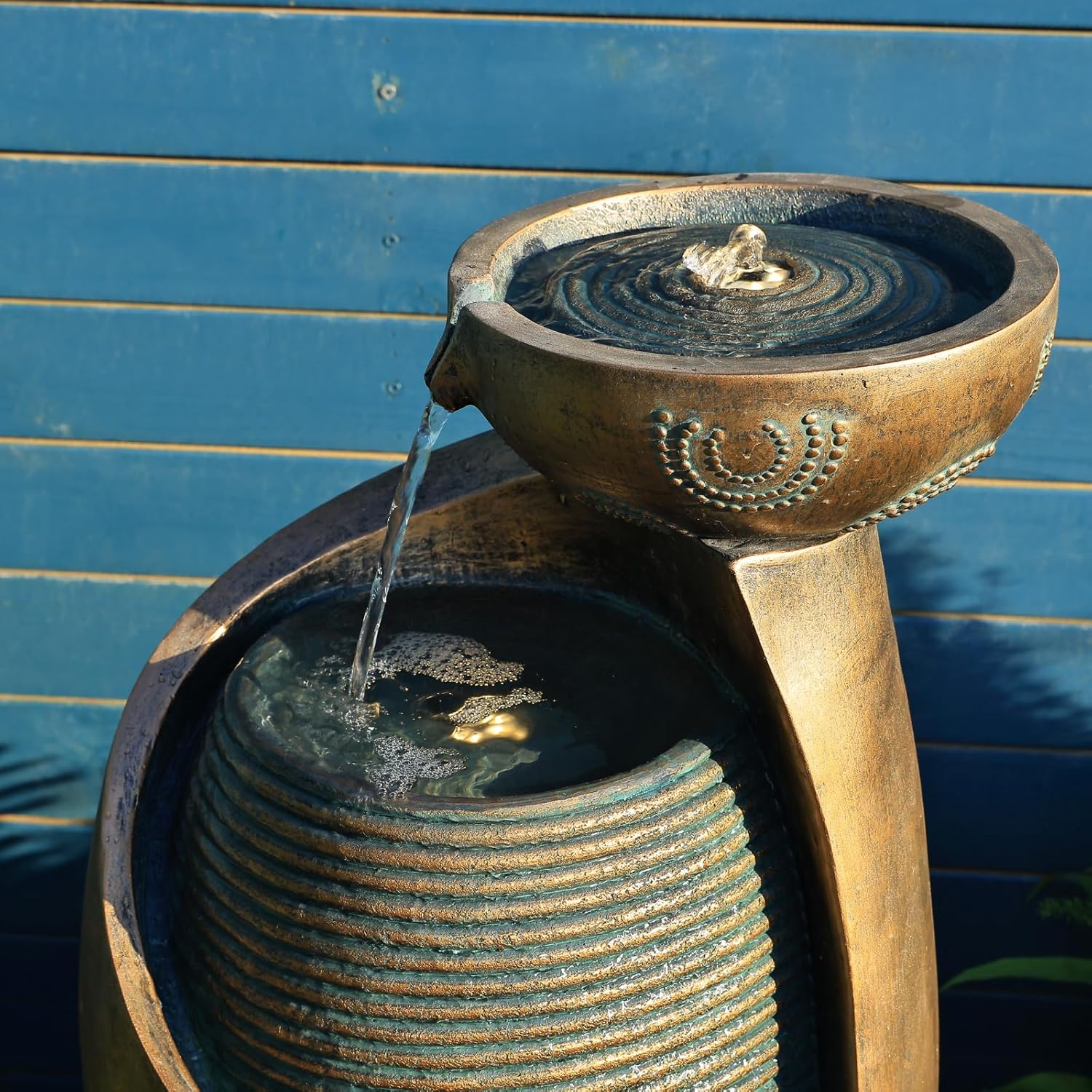 Close-up view of water flowing from the top bowl into the main body of the SERBILHOME fountain.