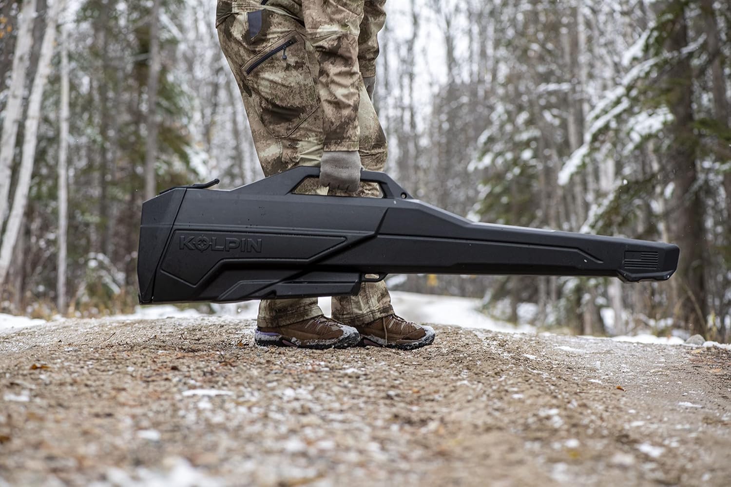 Person carrying Kolpin Gun Boot by integrated handle