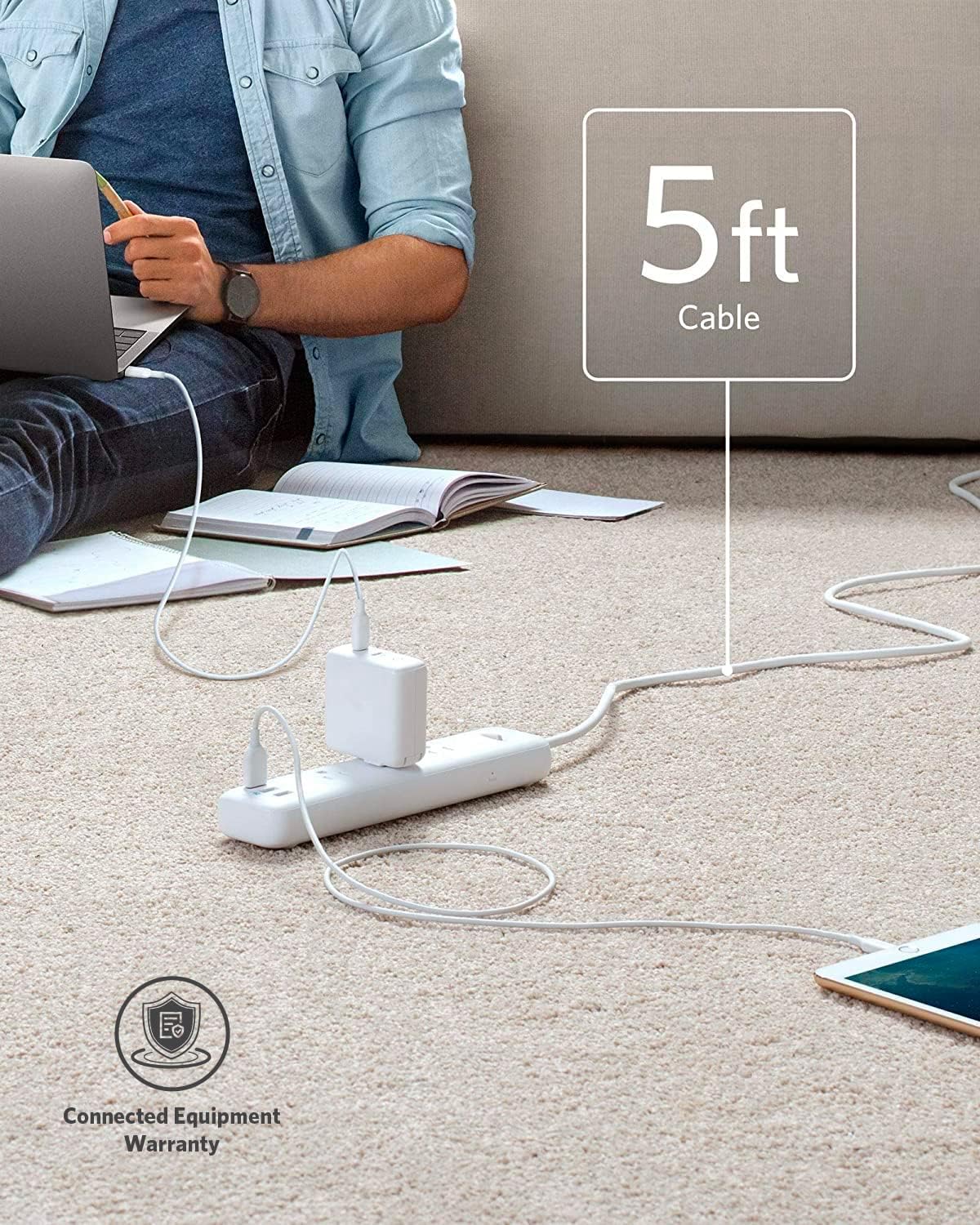 Anker PowerPort Strip 3 with its 5-foot cable extending across a carpeted floor, connected to a wall outlet