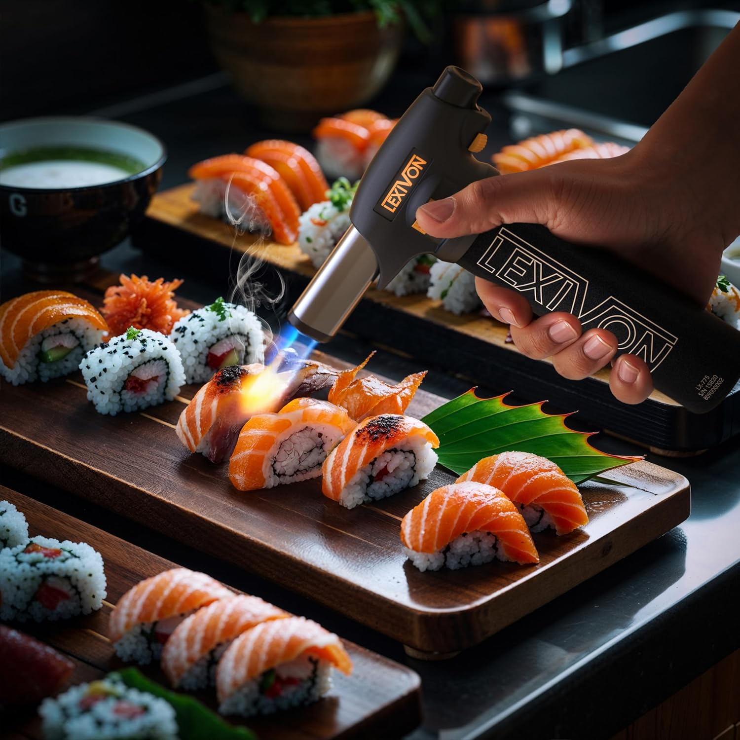 A hand using the LEXIVON Butane Torch Lighter to sear sushi.