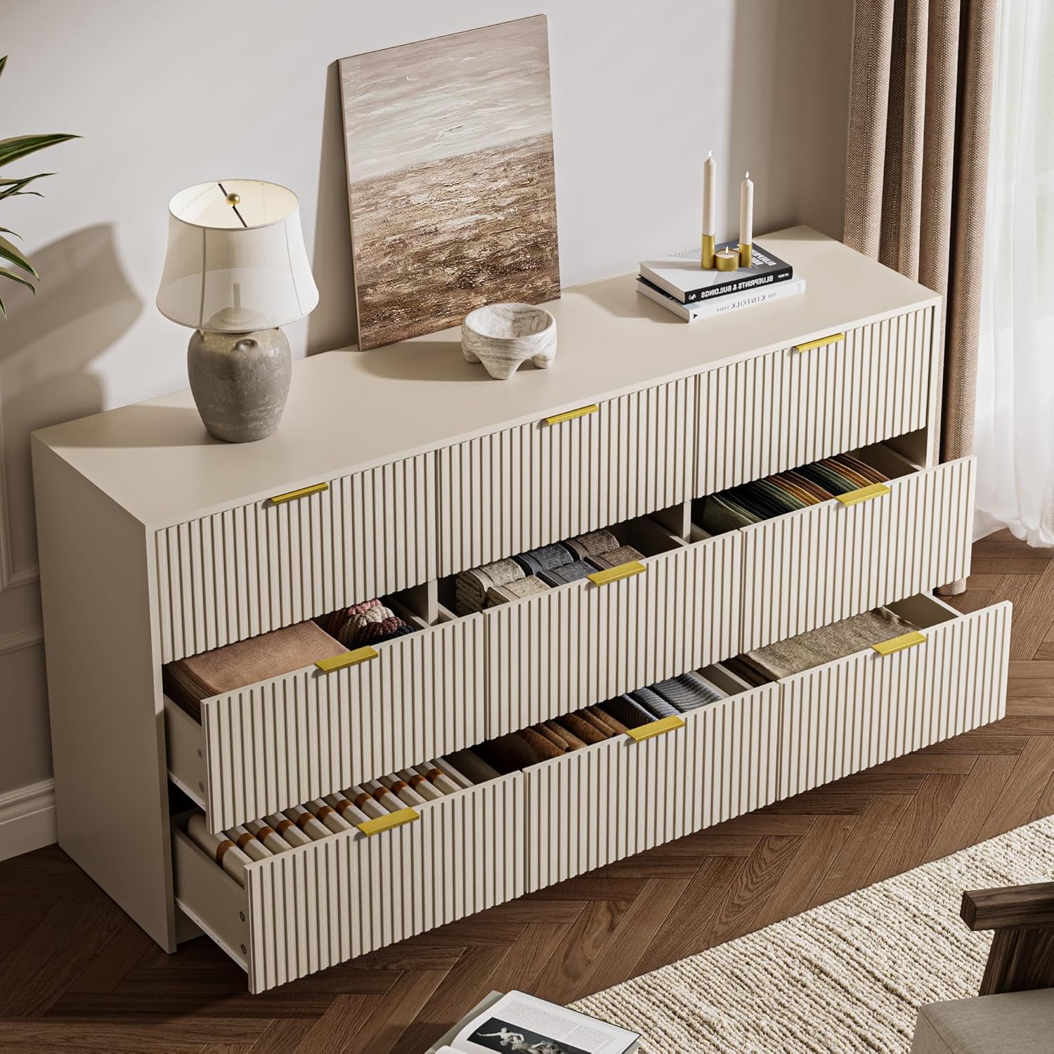 MAISONARIA Beige 9-Drawer Double Dresser with several drawers open, revealing neatly folded clothes inside.