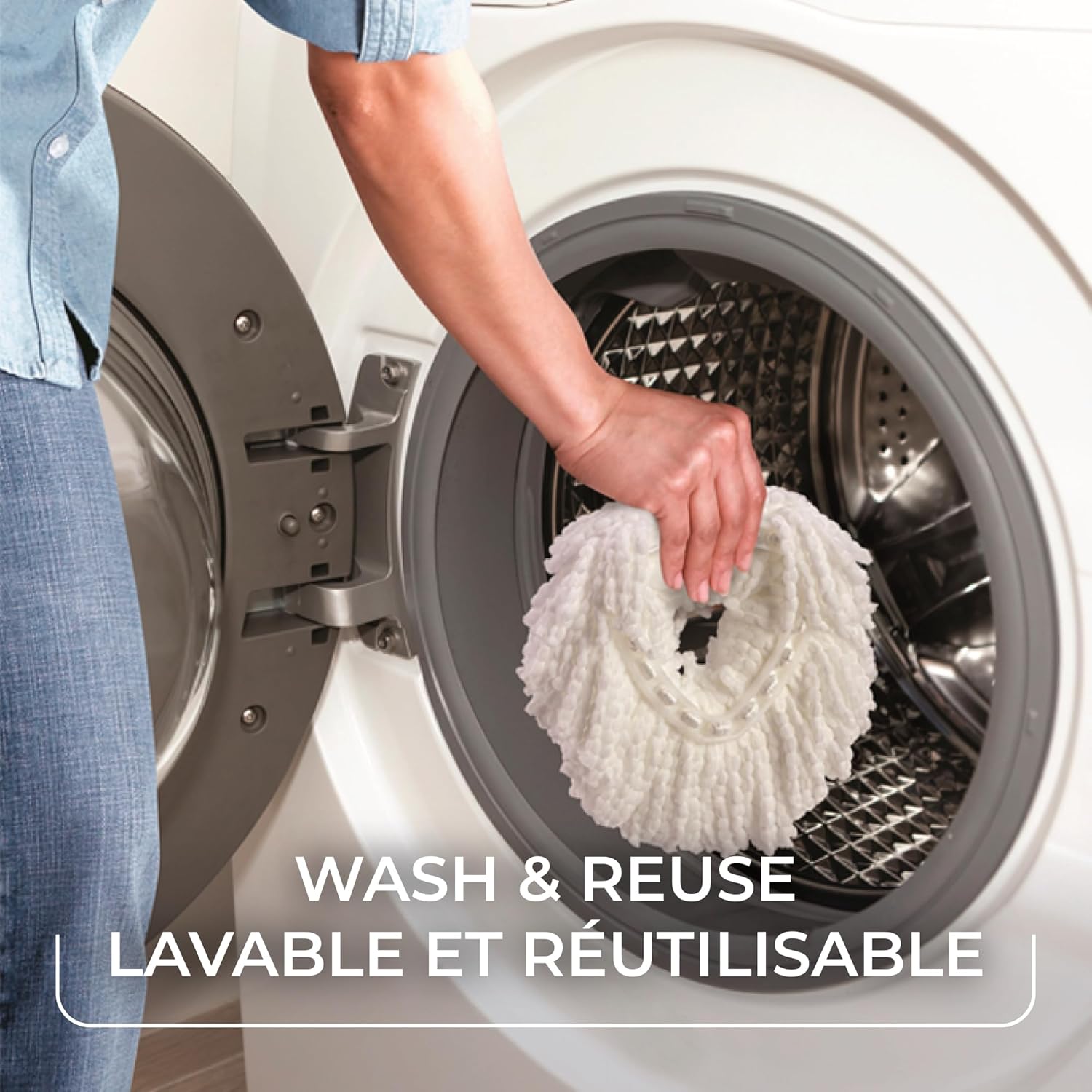 A person placing a Vileda EasyWring mop head into a washing machine for cleaning.
