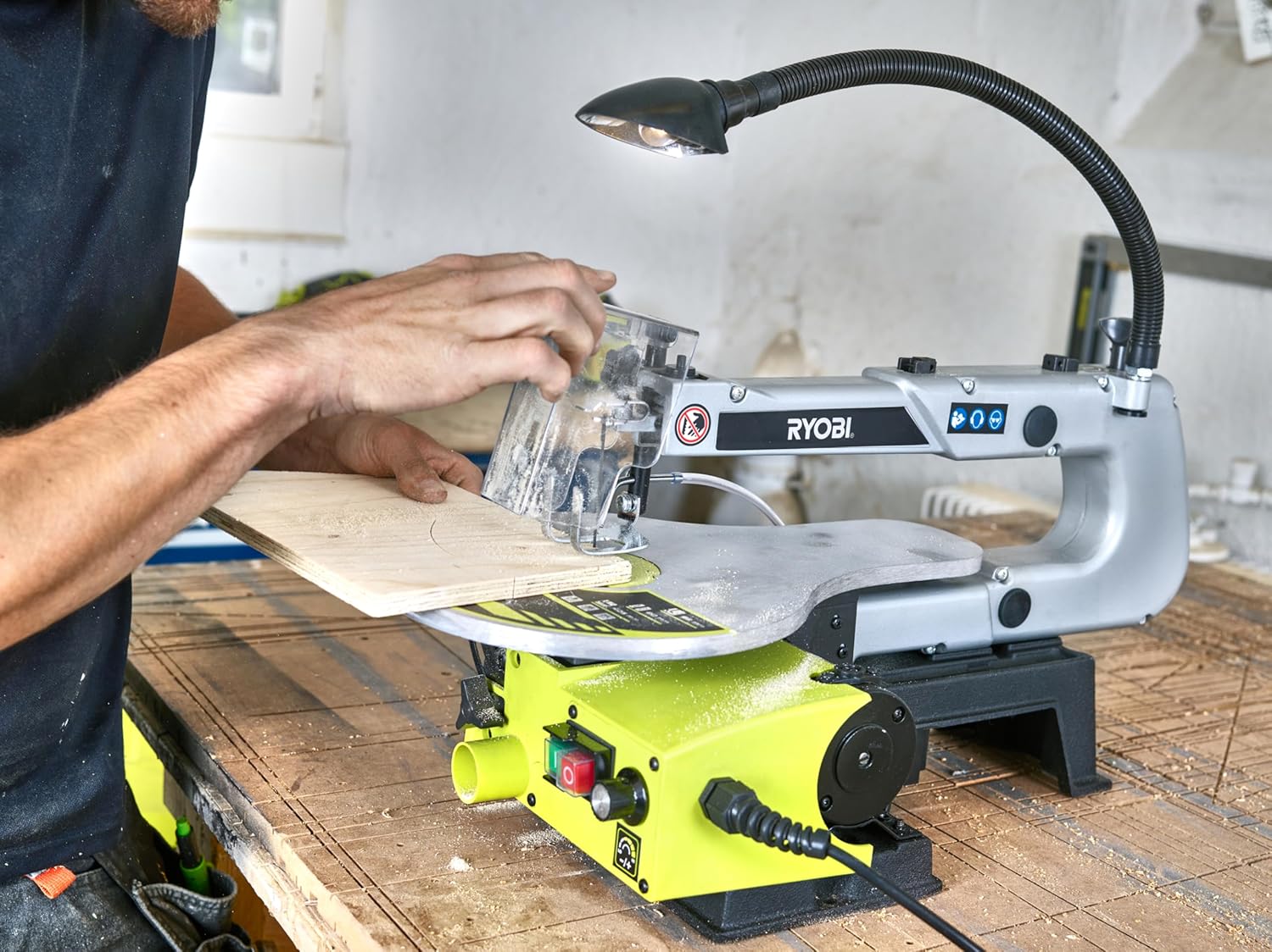 інший view of the Ryobi RSW1240G Scroll Saw being used, showing the stable base and the user's hands guiding the material.