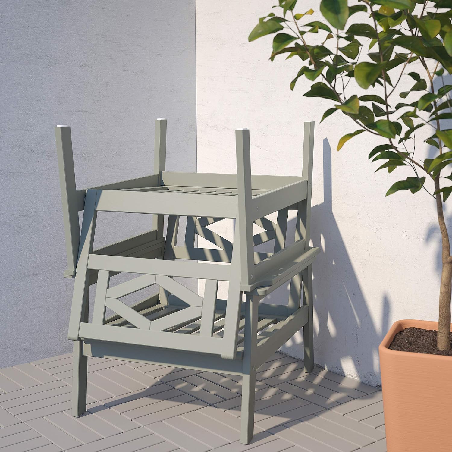 Two IKEA BONDHOLMEN Outdoor Armchairs stacked for storage.