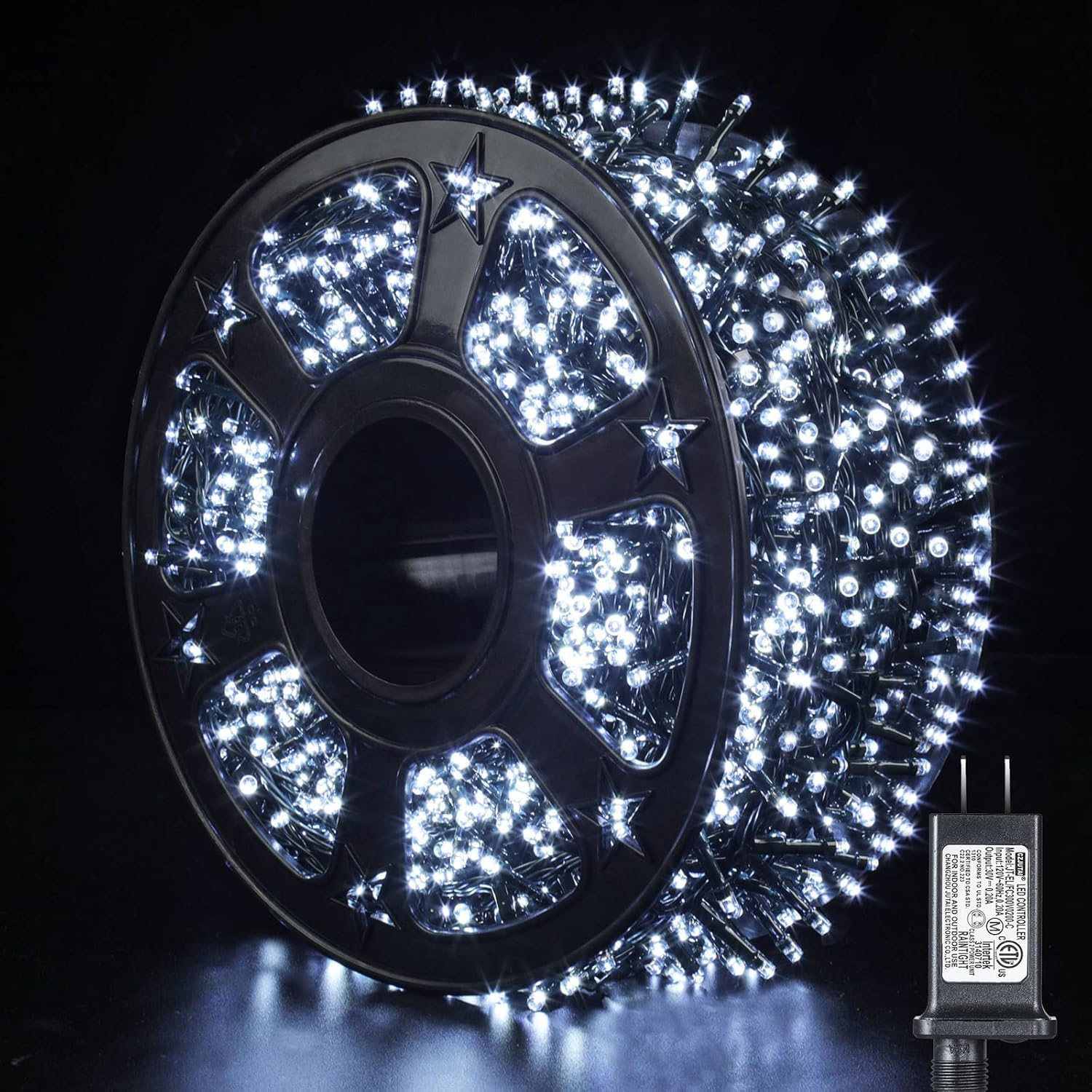 Quntis 82ft 1000 LED Cluster Christmas String Lights neatly wound on a plastic reel, with the power adapter visible.