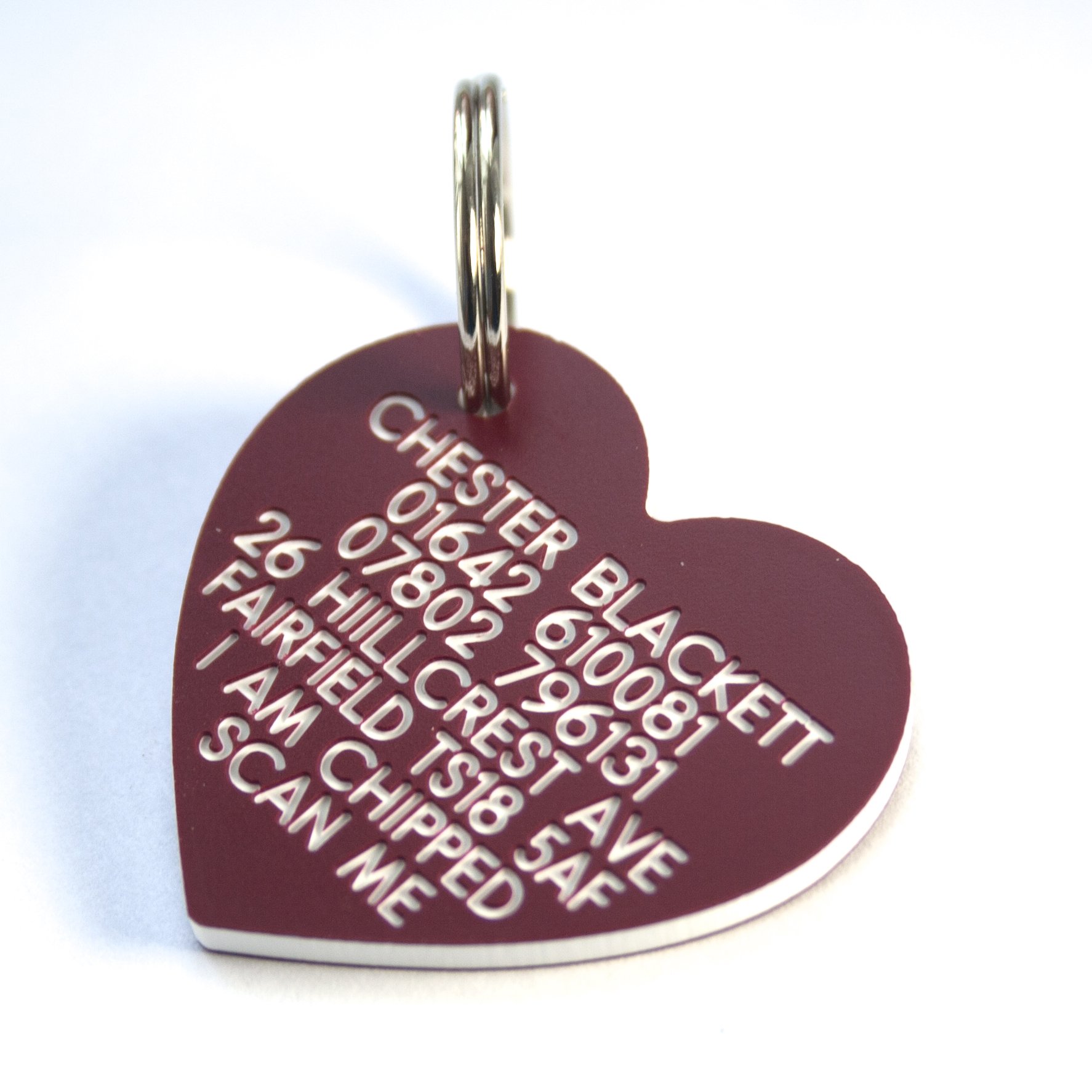 Engraving Studios Deeply engraved ruby plastic heart shaped dog tag. 41mm x 38mm