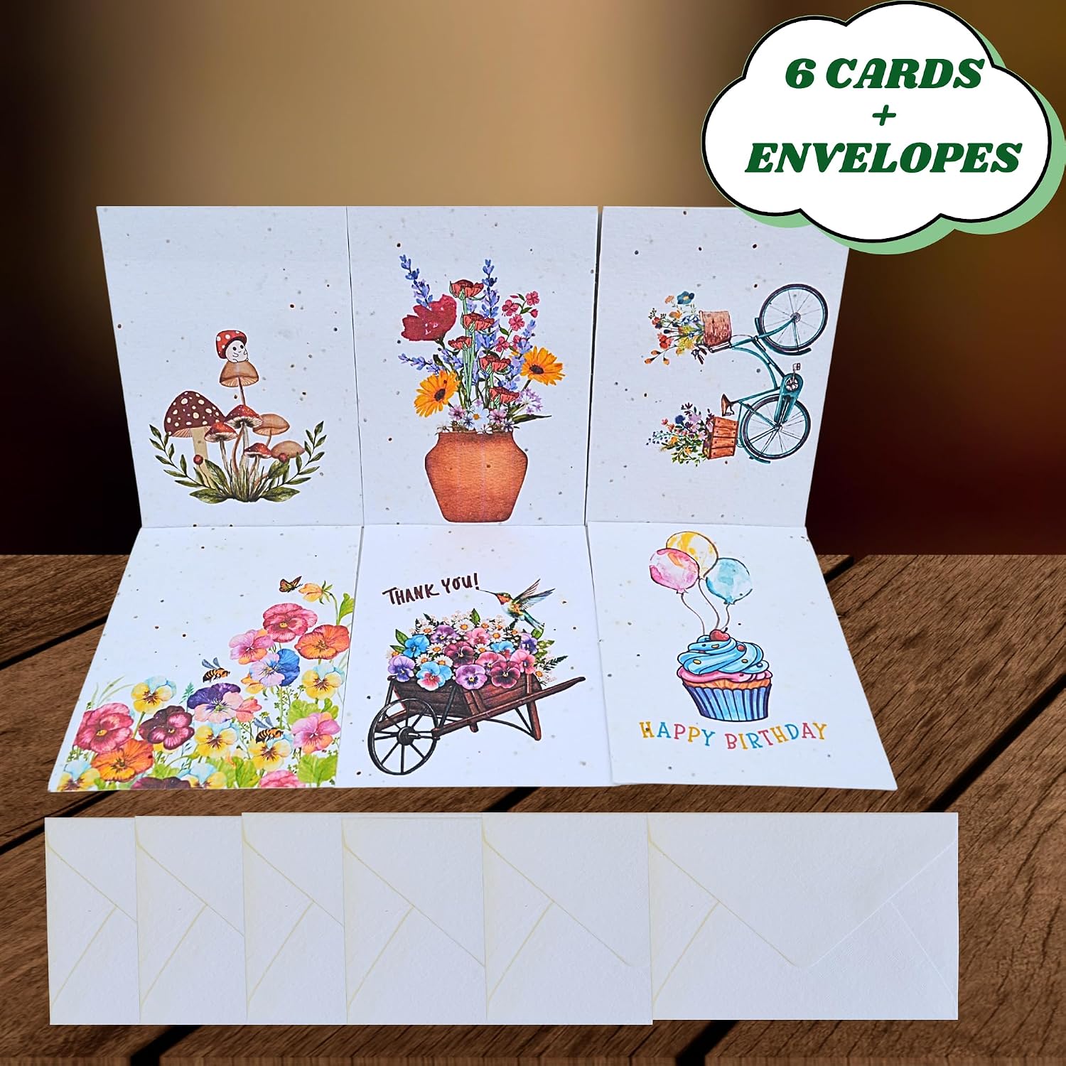 Six plantable greeting cards with various designs and six white envelopes