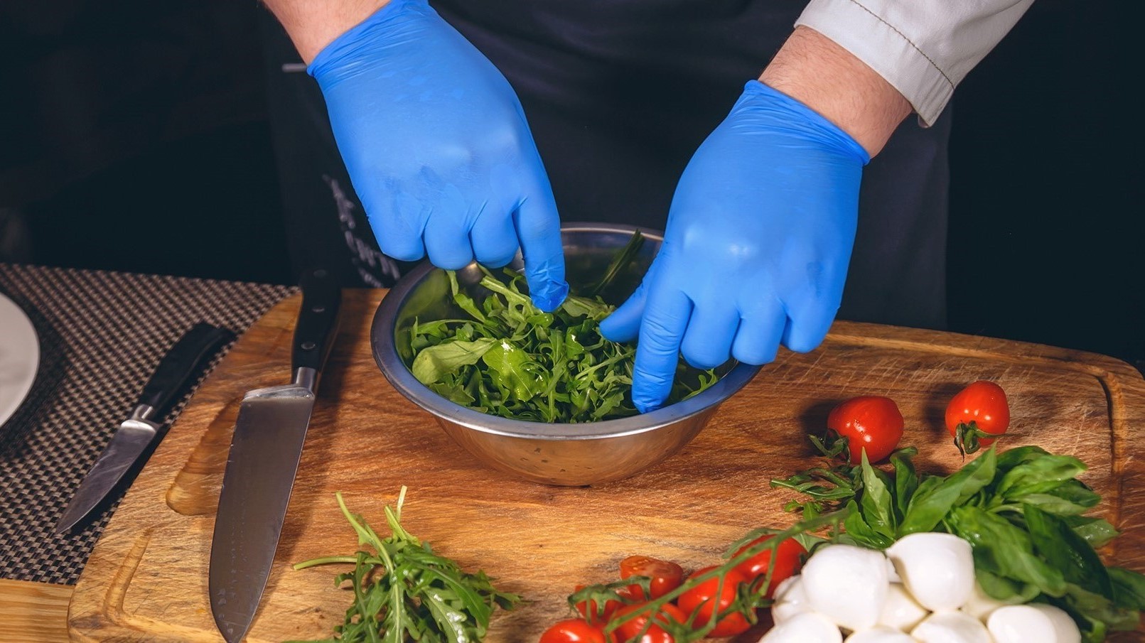 Supmedic nitrile glove in use for kitchen food prep holding vegetables with strong grip