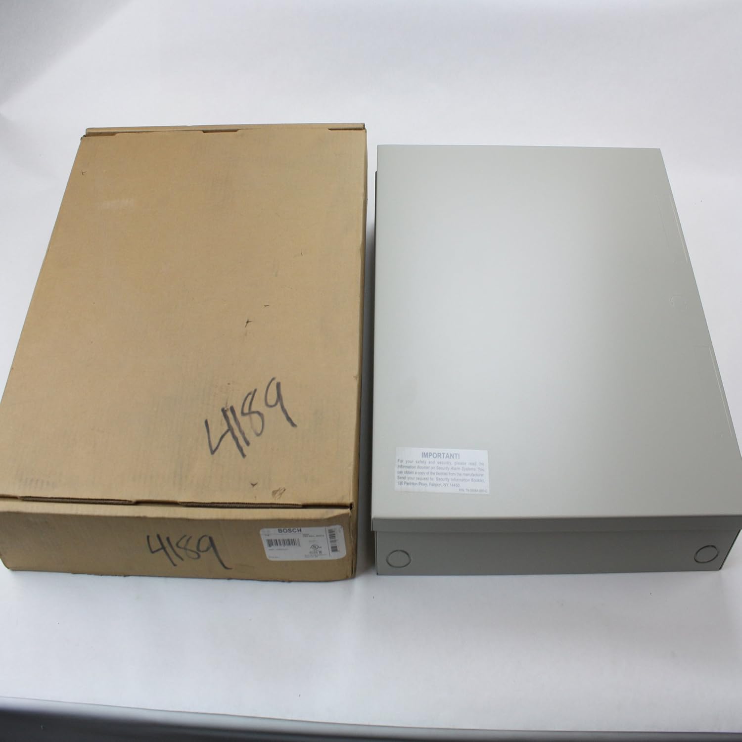 Back of the Bosch D8103 enclosure with an important safety sticker