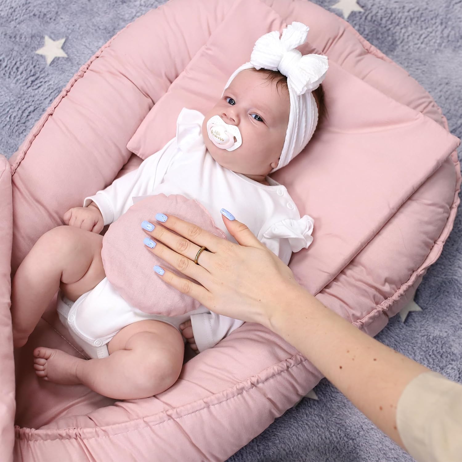Baby in nest with thermal cushion