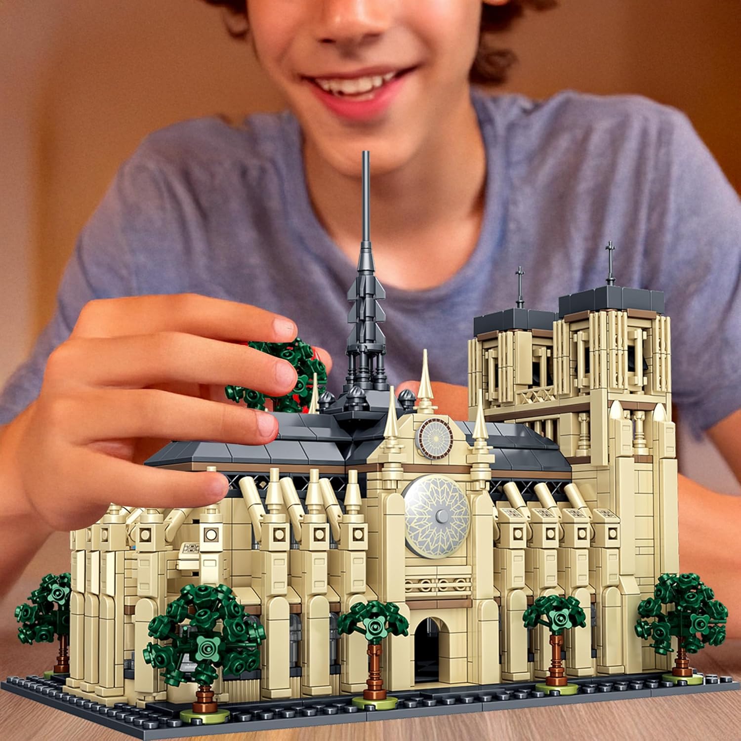 A person assembling the micro building blocks model of Notre Dame de Paris.