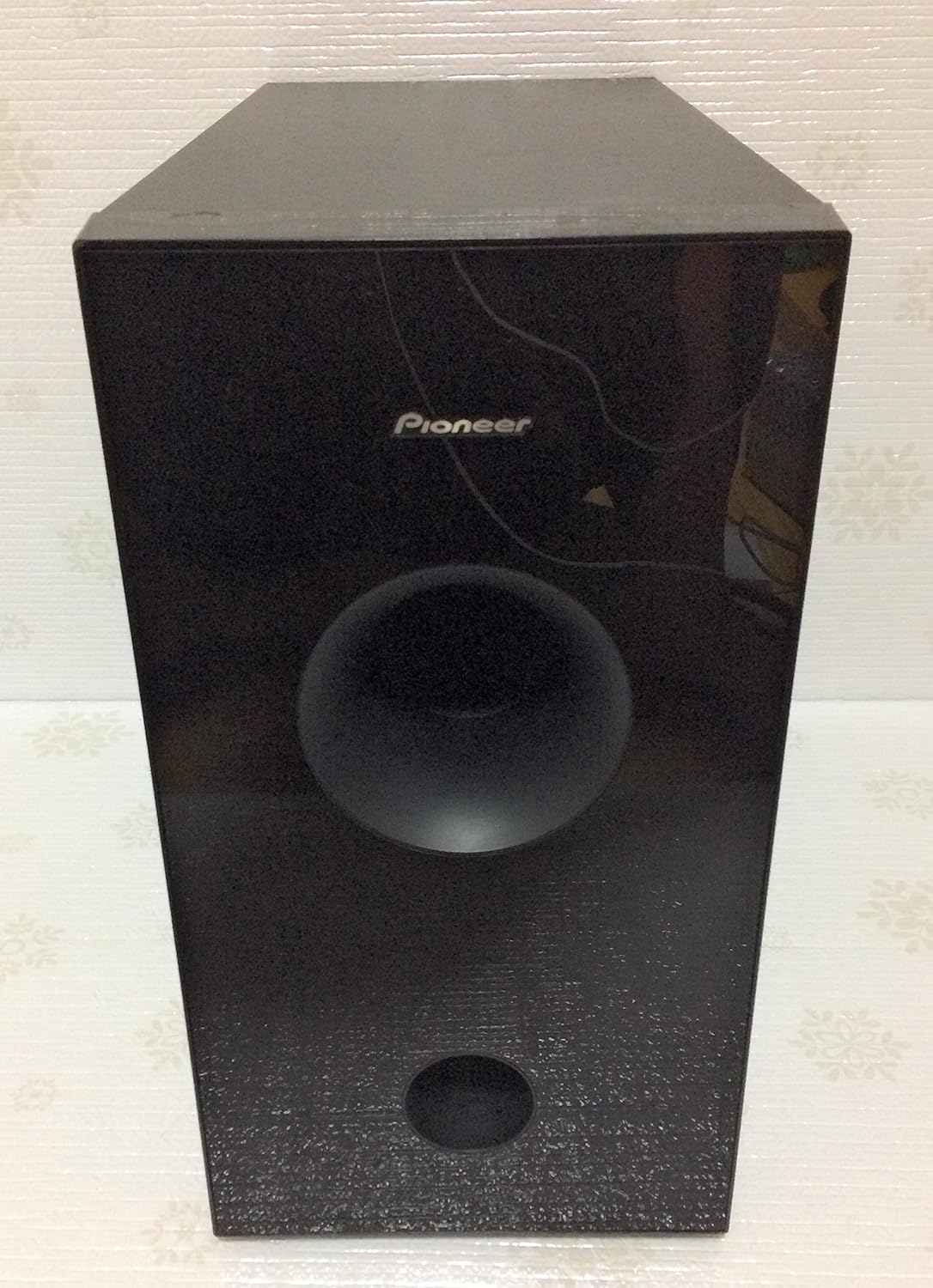 פראָנט view of the Pioneer HTP-S313 subwoofer, showing the Pioneer logo and speaker grille.
