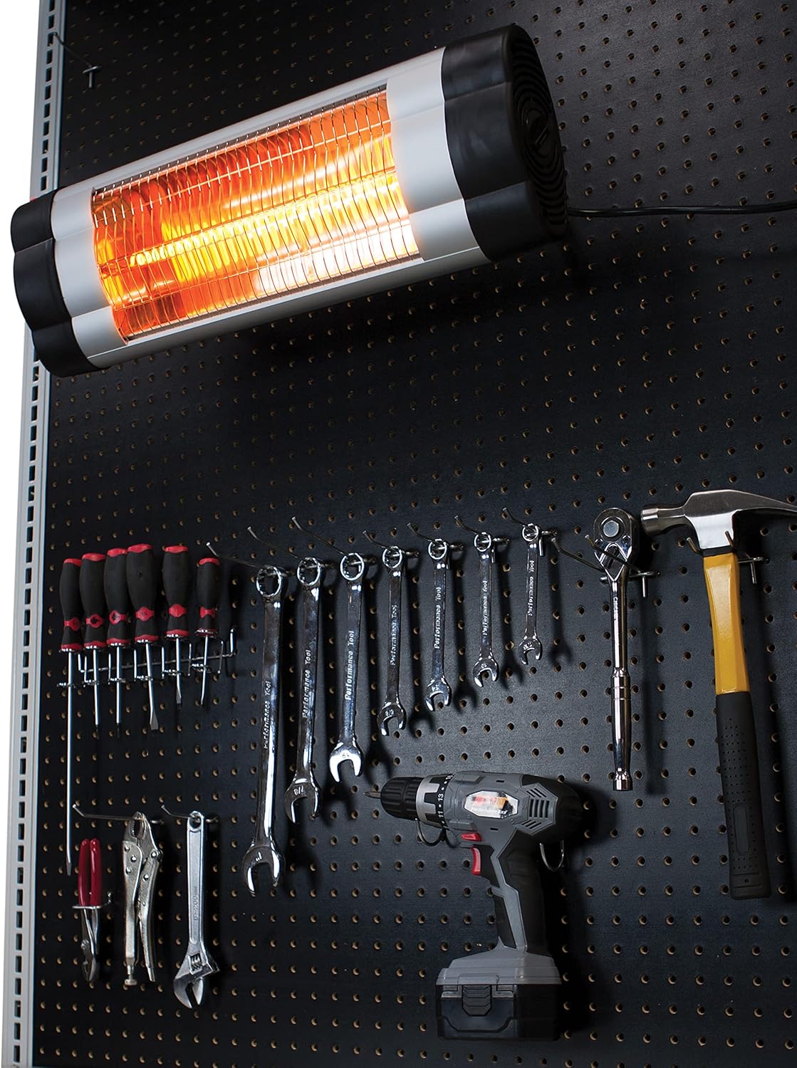 Performance Tool W5008 Infrared Heater mounted on a pegboard wall in a workshop.