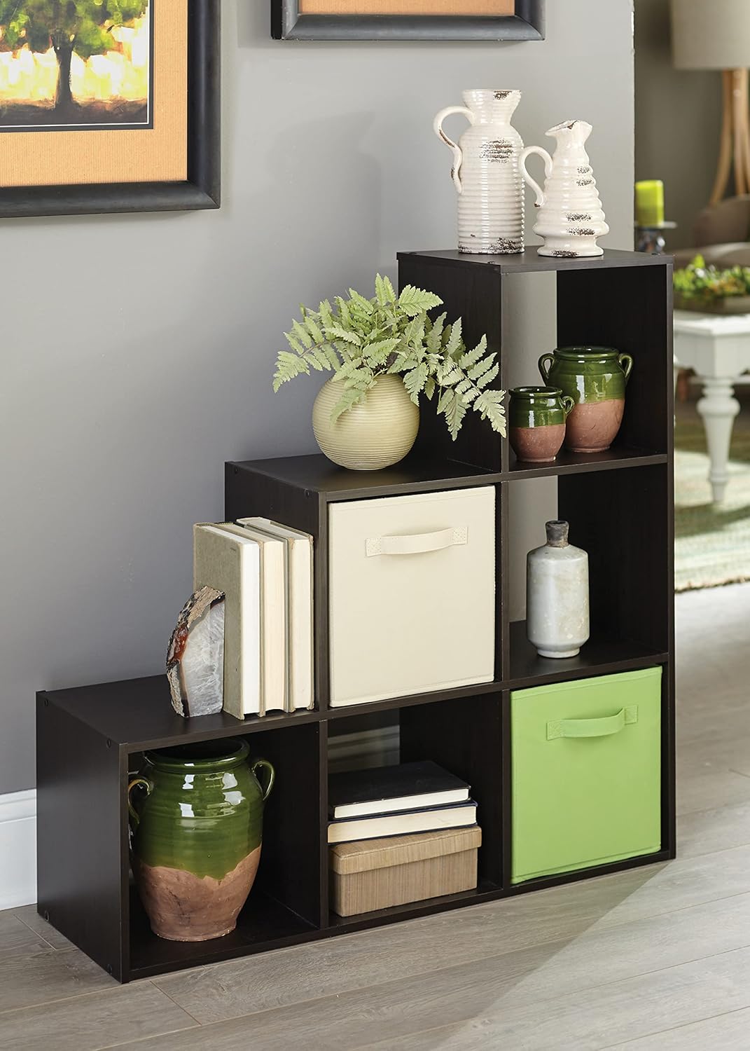 Lifestyle image of the ClosetMaid Cubeicals 3-2-1 Cube Organizer filled with books, decorative items, and fabric bins