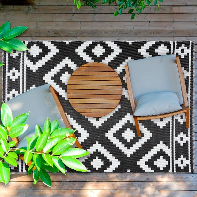 Lightweight reversible budget outdoor rug rolled on a deck