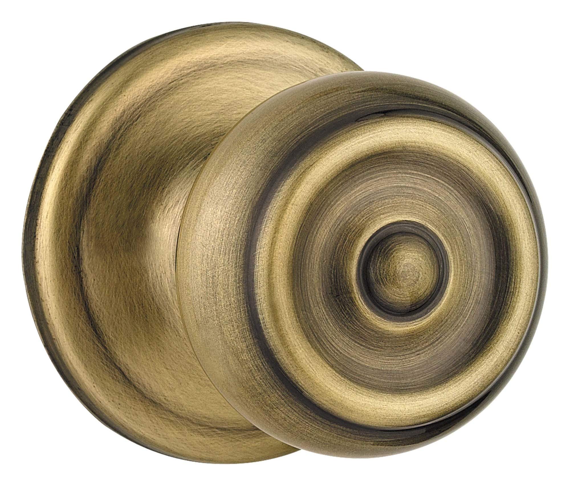 Poignée de porte intérieure Kwikset Phoenix laiton antique monocylindre à clé