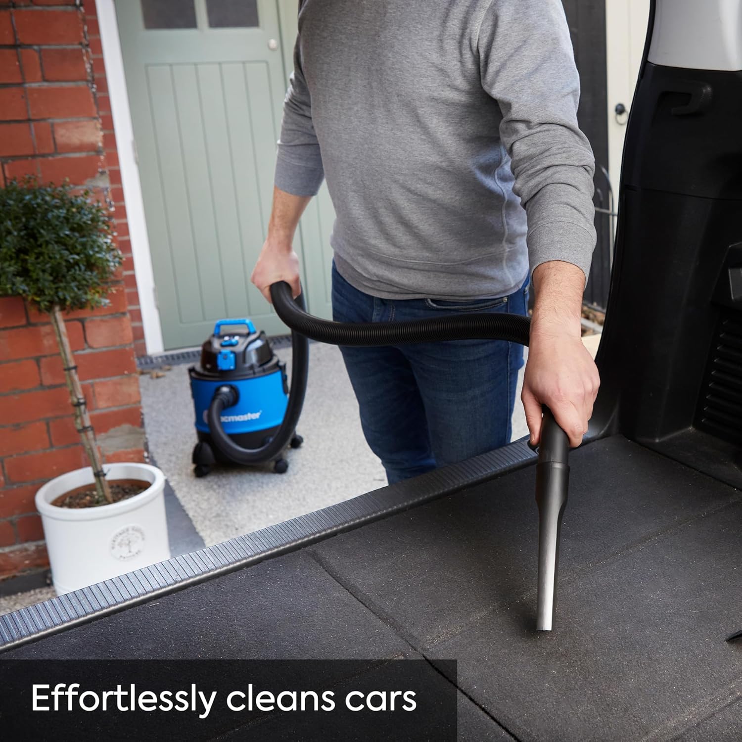 Person cleaning car interior with Vacmaster VQ1220PFC