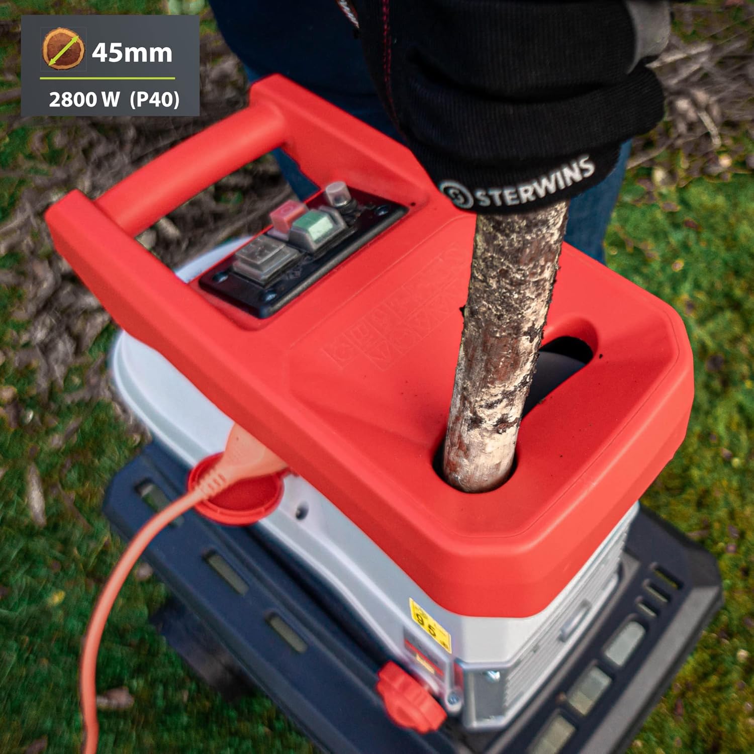 Person feeding a branch into the shredder