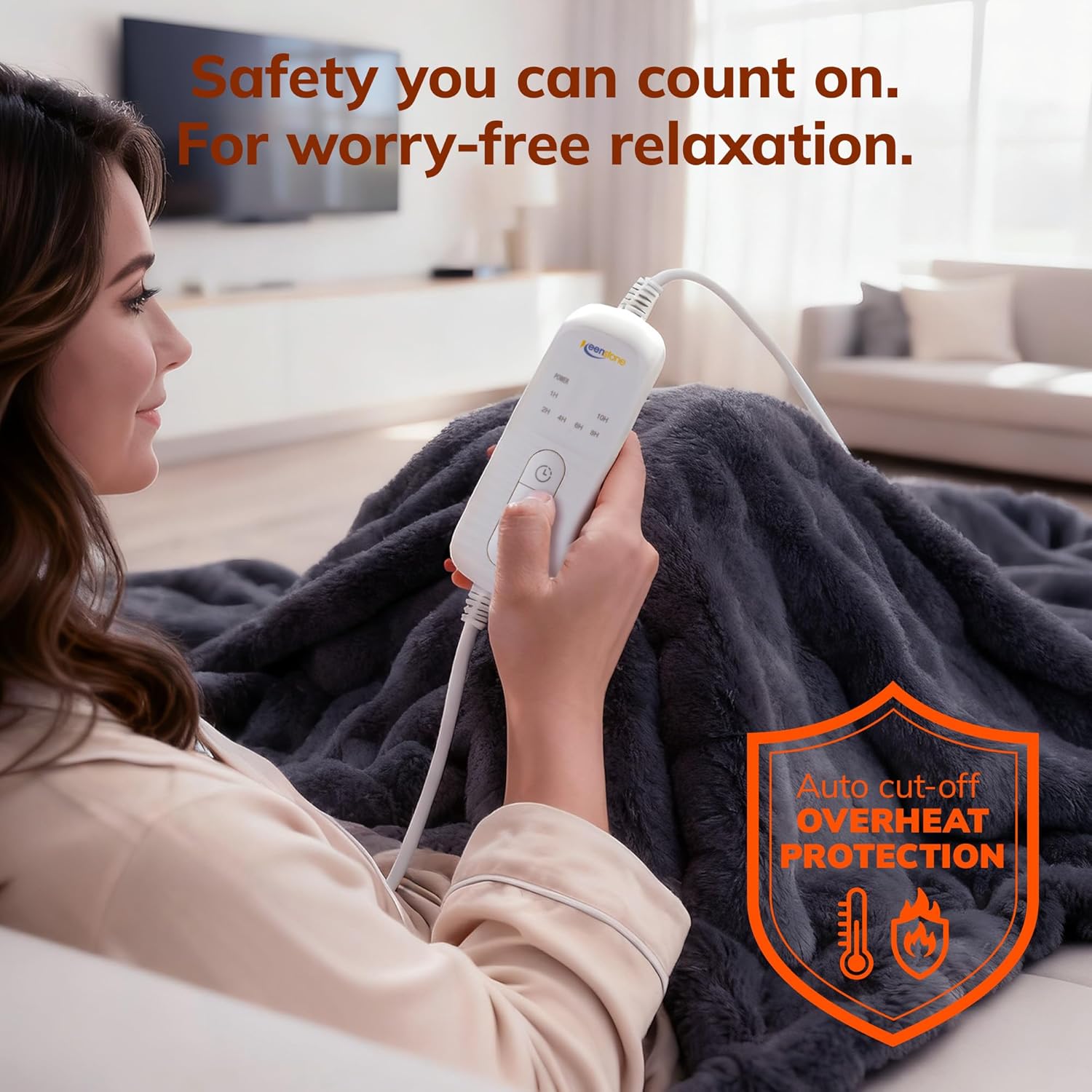 Image of a woman relaxing on a sofa with the Keenstone heated blanket, holding the controller. The image highlights 'Auto cut-off Overheat Protection' with an icon.