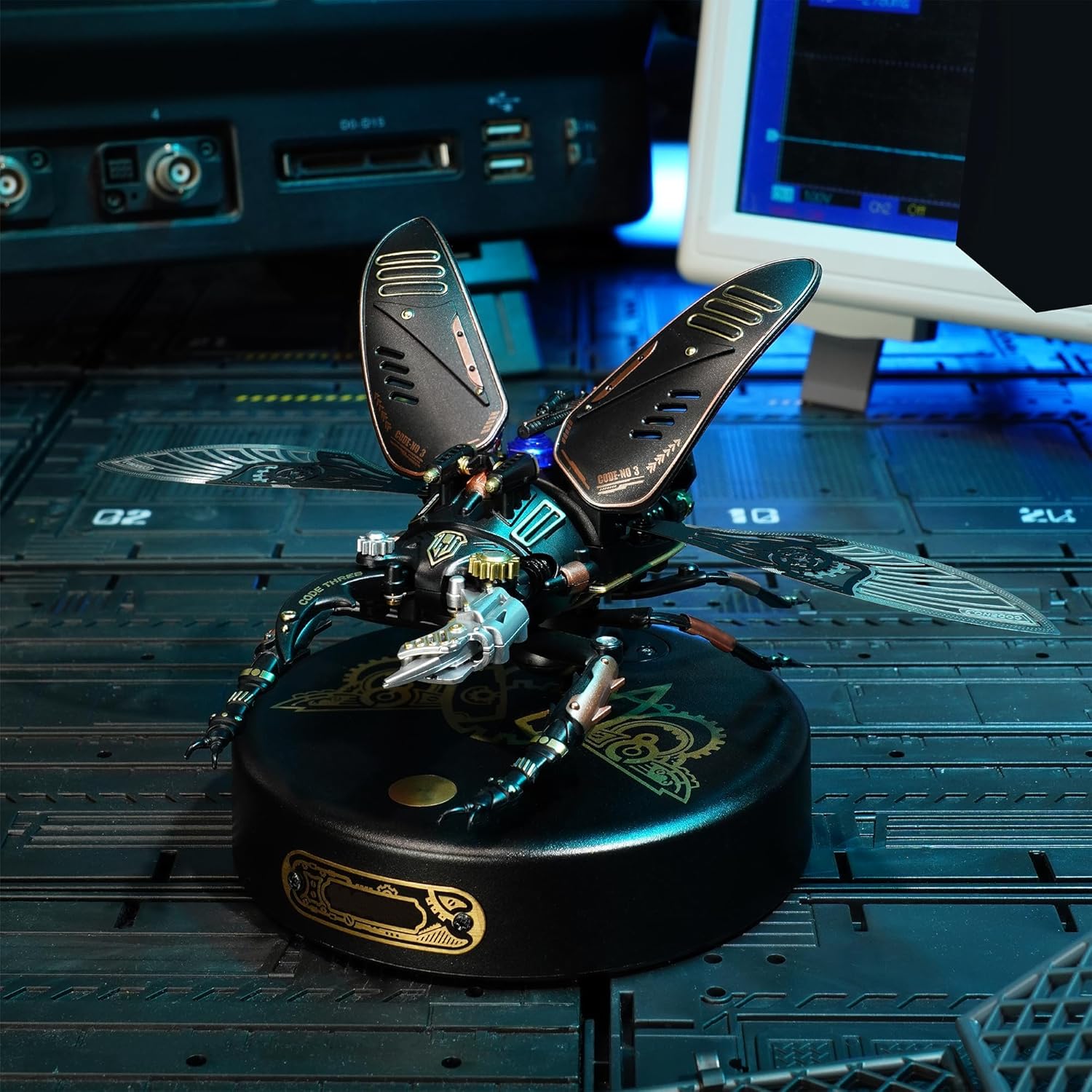 The assembled Storm Beetle model displayed on a desk, with its wings open and blue LED light illuminated, showcasing its operational state.