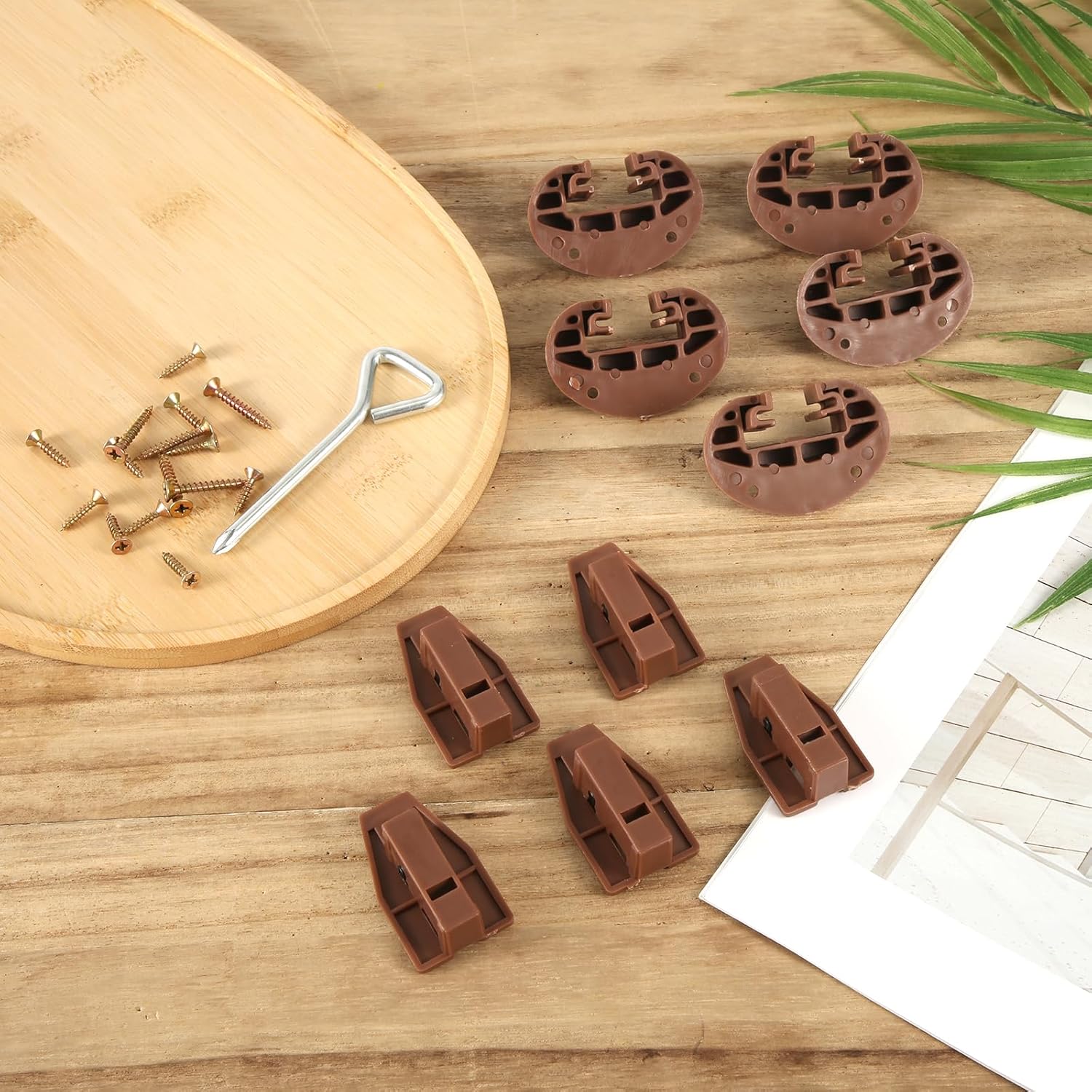 Components of the NQEUEPN Drawer Guide Kit laid out on a wooden surface, including the brown plastic track box rails, track rails with rollers, mounting screws, and a screwdriver.