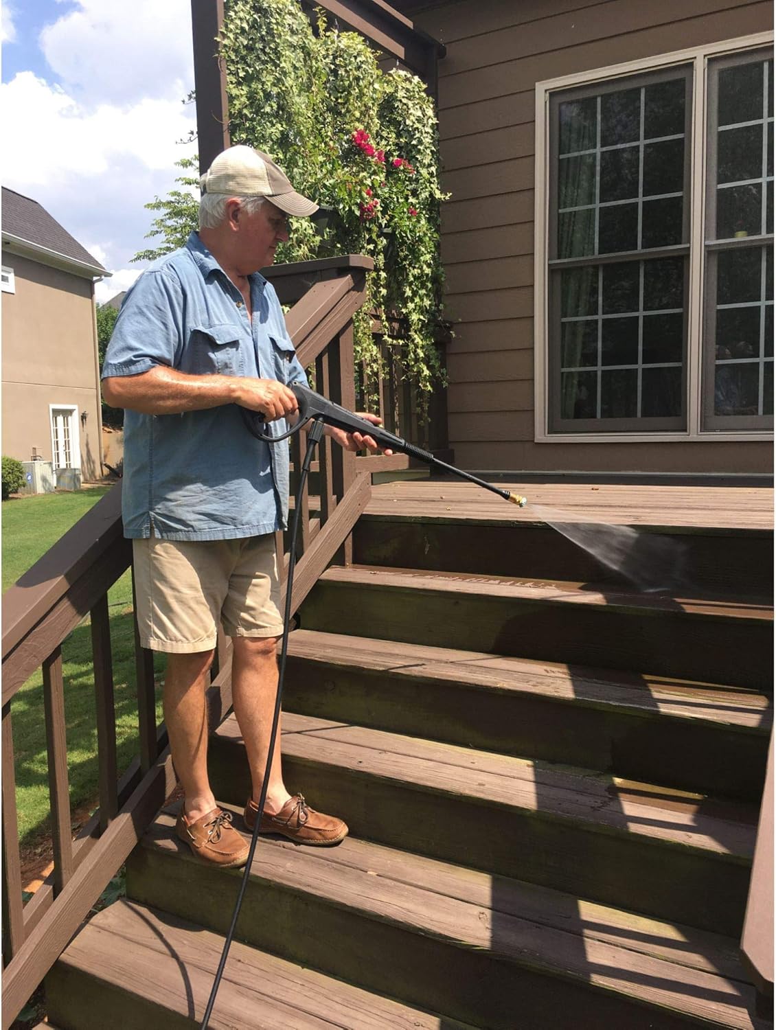 Person using Yard Force MC1800 pressure washer on a deck