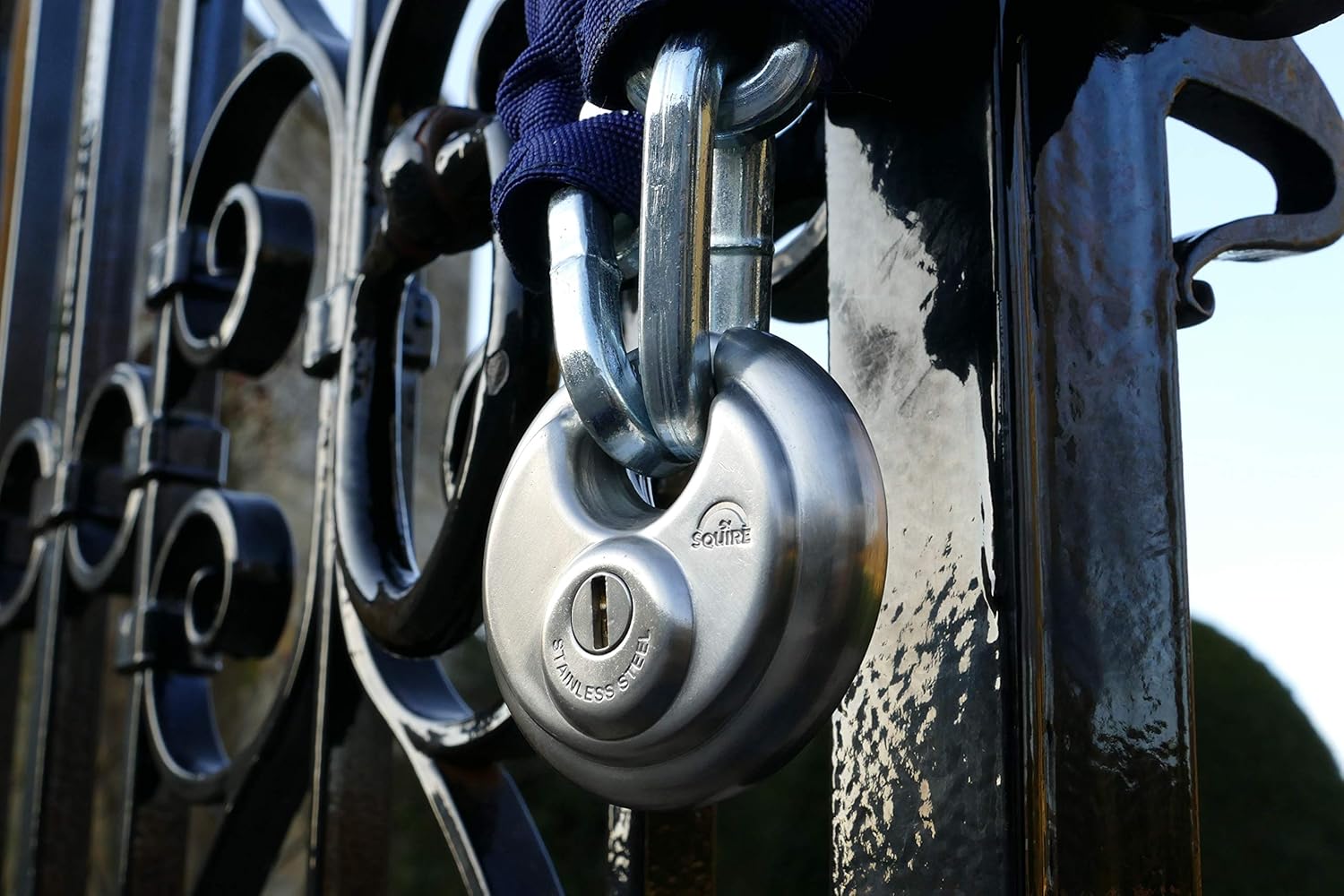 Henry Squire padlock securing a metal gate with a chain