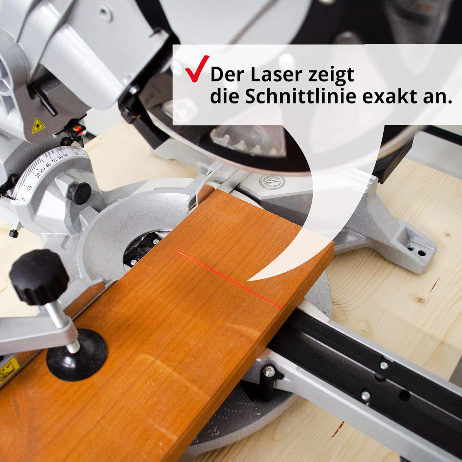 Close-up of the Hecht 828 miter saw's laser projecting a red line onto a wooden workpiece