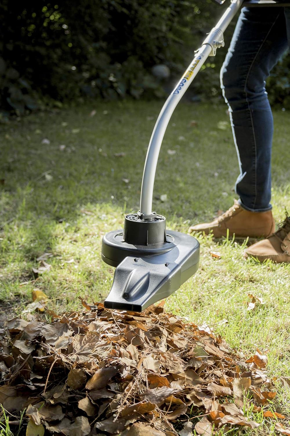 Person using the IKRA IBKH 52 as a leaf blower to clear leaves