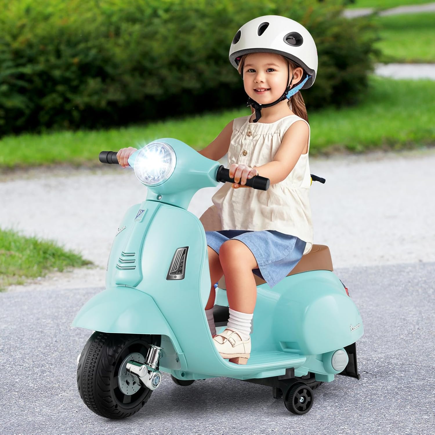 Child riding green OLAKIDS Licensed Vespa Scooter