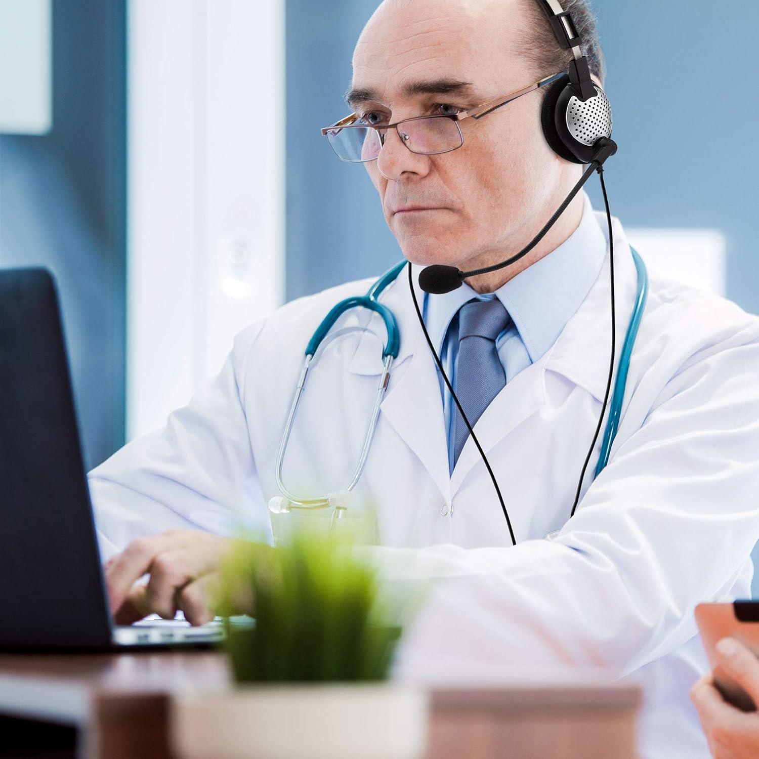 Doctor using Andrea Communications NC-185 VM Headset during a virtual consultation