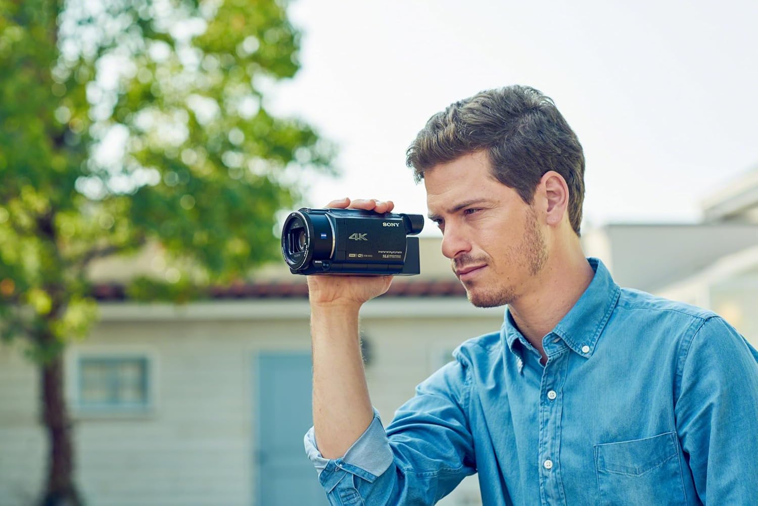 Man Filming with a Sony 4K Camcorder
