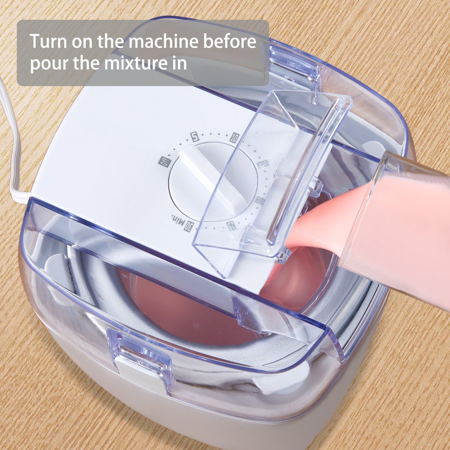 Pouring ice cream mixture into the Aicok Ice Cream Maker through the lid's spout.