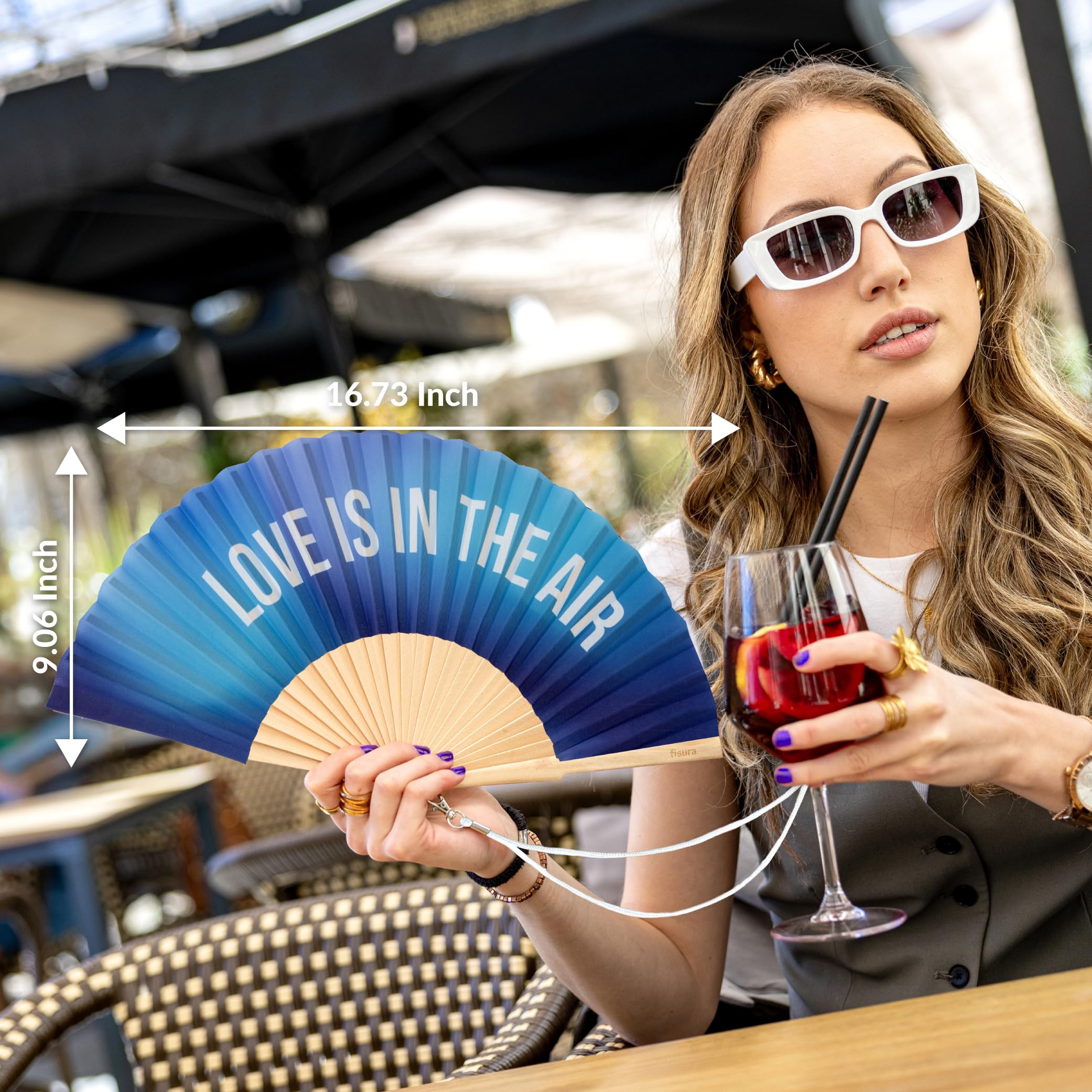 Fisura – Oryginalny wachlarz z napisem “love is in the air”, idealny na ślub. Drewniany model z niebieskim gradientem. W zestawie pasek do zawieszenia. Wymiary: 42,5 x 23 cm