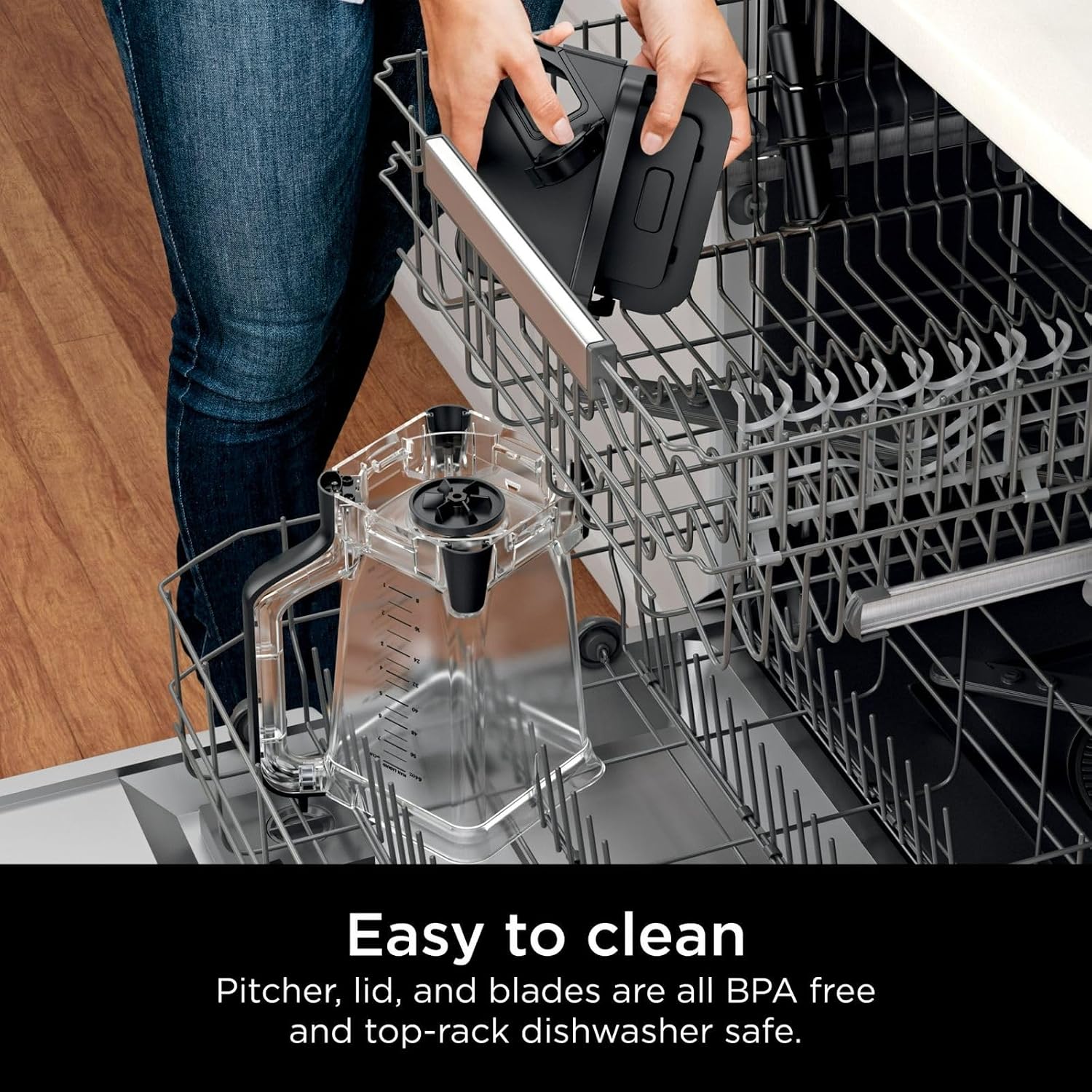 The Ninja Grand Kitchen System KS500 with a single-serve cup attached to the motor base, containing blended fruit and greens. The text highlights the convenience of blending directly in the cup for on-the-go drinks.