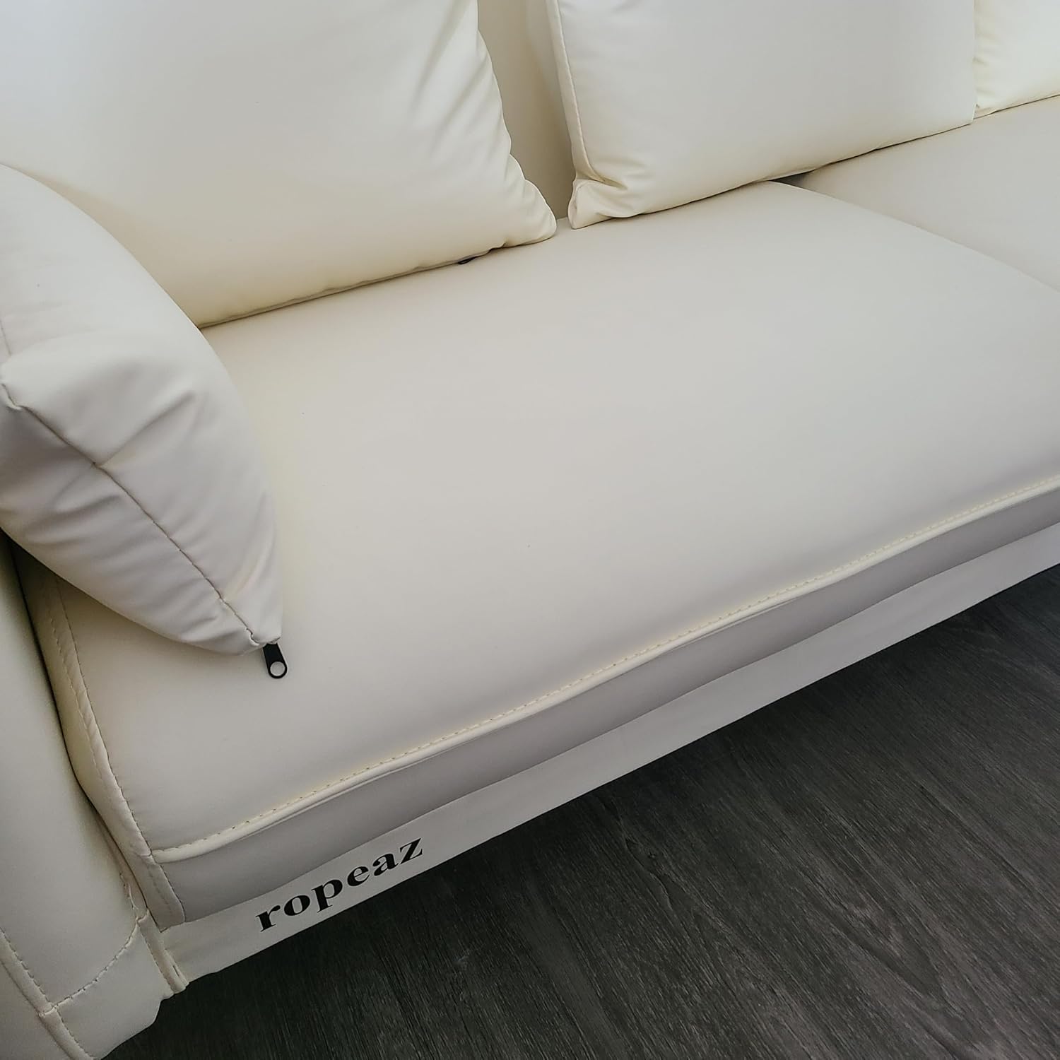ropeaz Furniture A modern three-seater sofa in cream white with removable cushions, suitable for various spaces including living rooms.