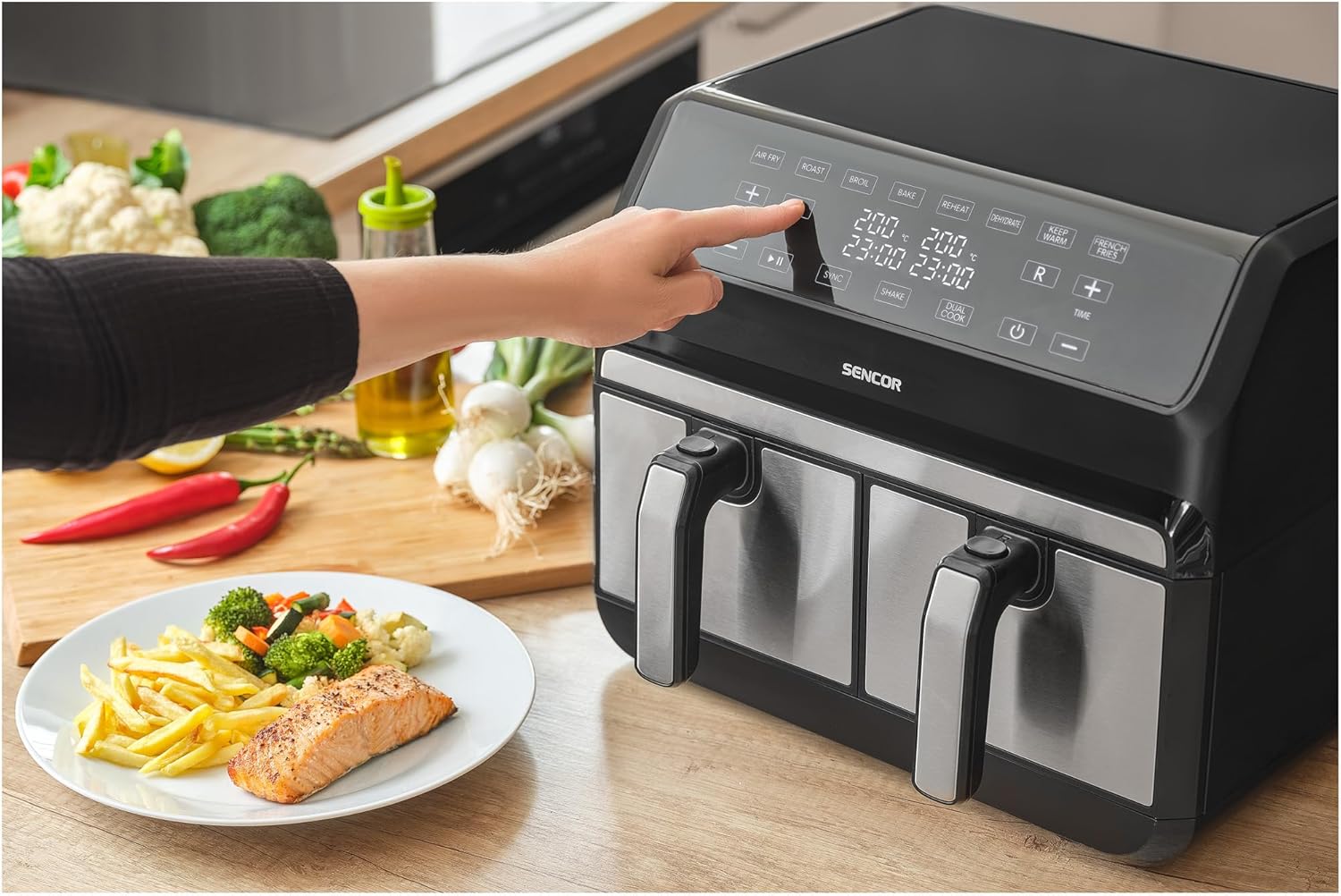 User interacting with SENCOR SFR 9500SS Air Fryer control panel