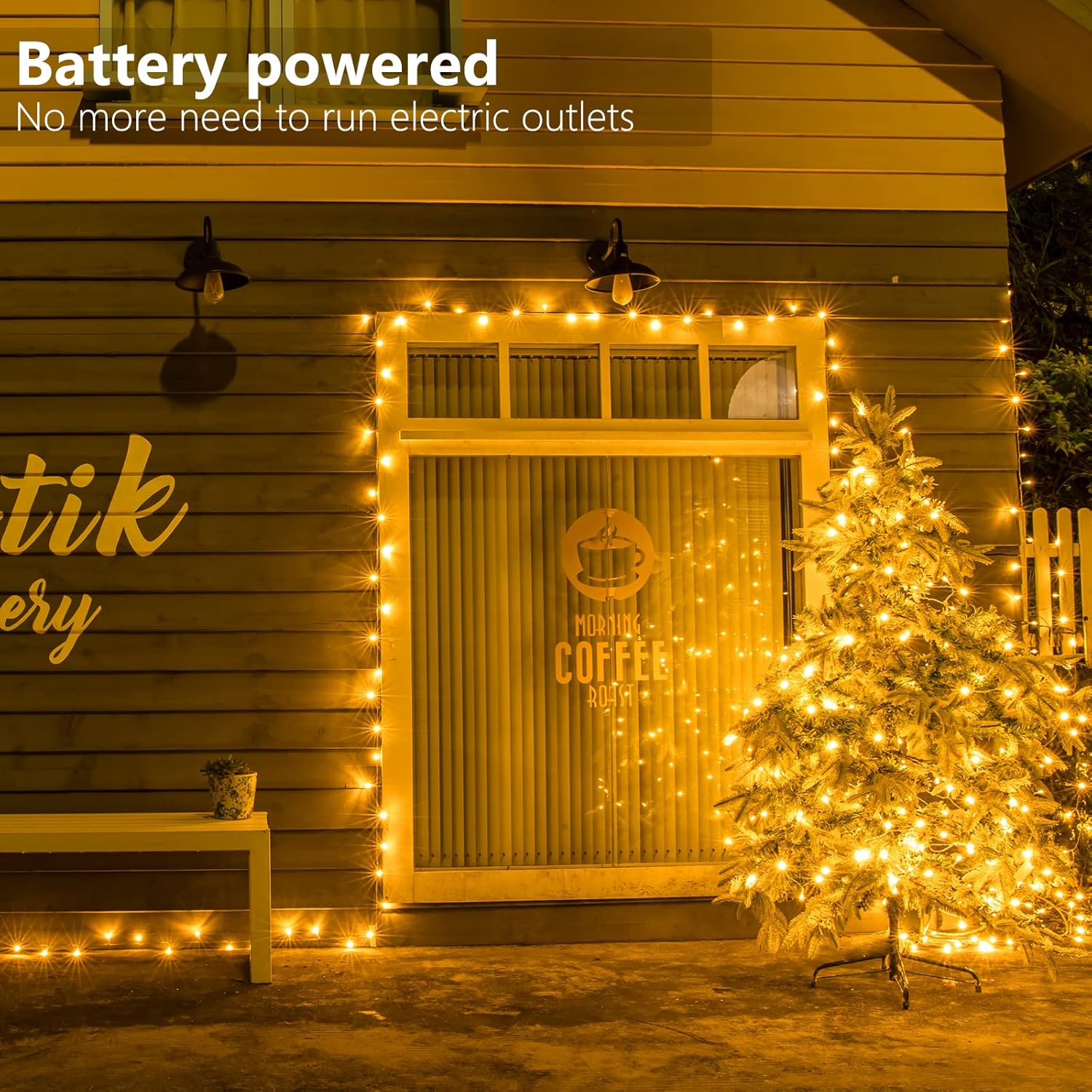 Battery powered string lights decorating the exterior of a house and a Christmas tree