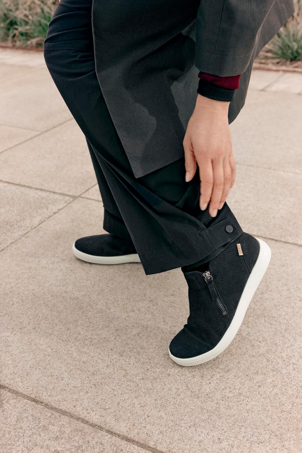 A person wearing the ECCO Soft 7 Low Bootie, demonstrating its fit and style.