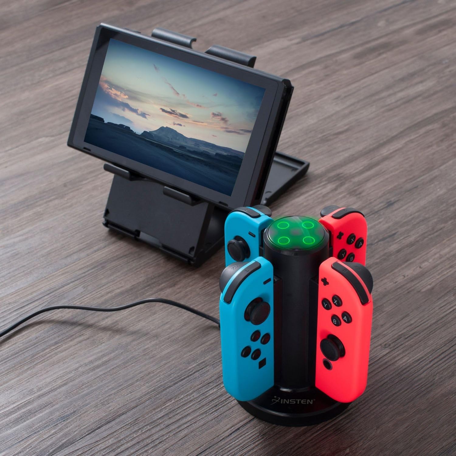 Insten Joy-Con Charging Dock in use, charging four controllers next to a Nintendo Switch console on a stand