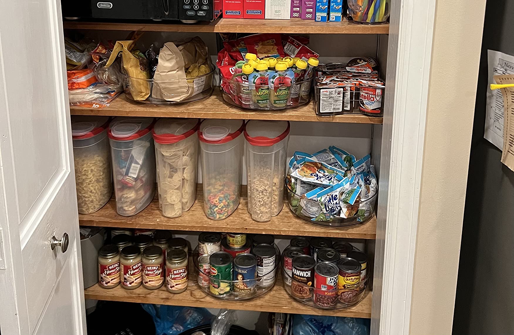 Lazy Susan turntable used to organize small snack items in a cabinet