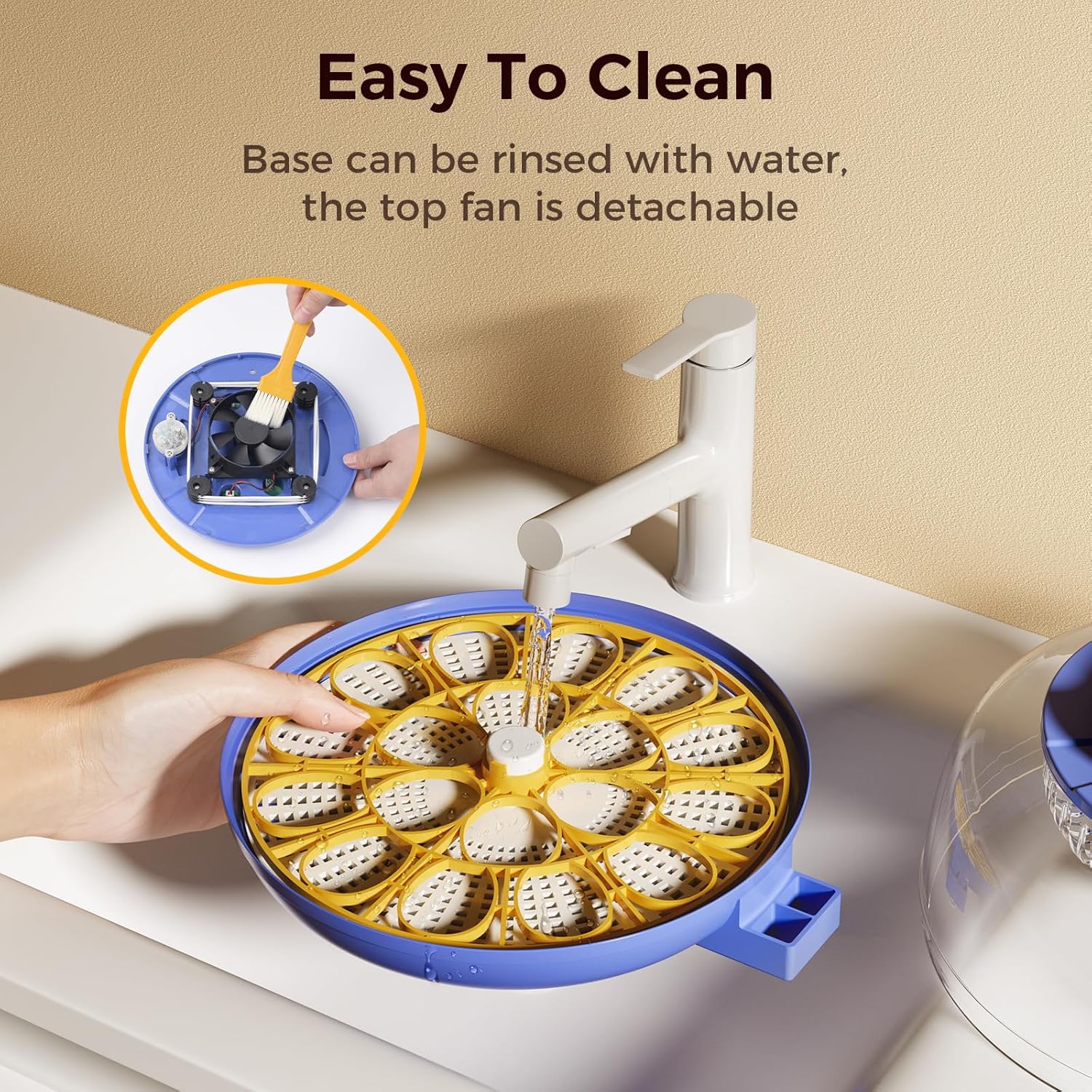 Incubator base being rinsed with water, showing detachable fan