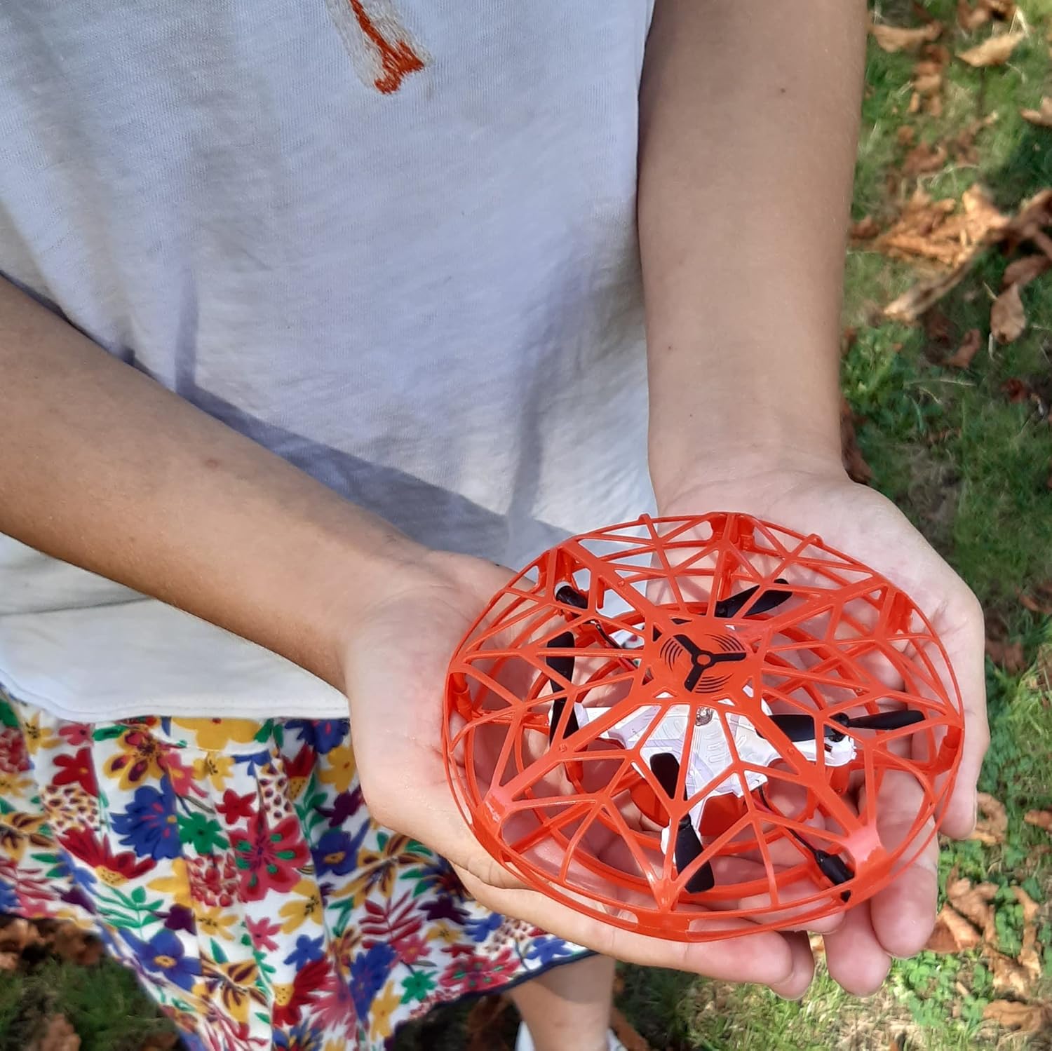 Hands holding the FLYBOTIC Mini Drone UFO