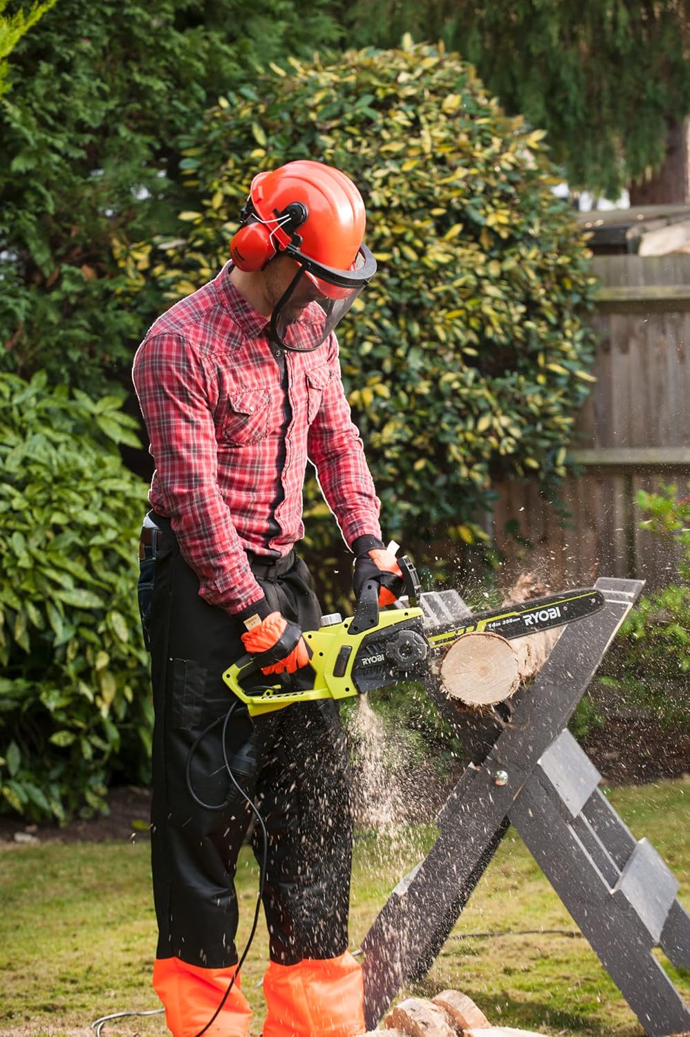 User operating RYOBI RCS1935B Electric Chainsaw with wood on a sawhorse