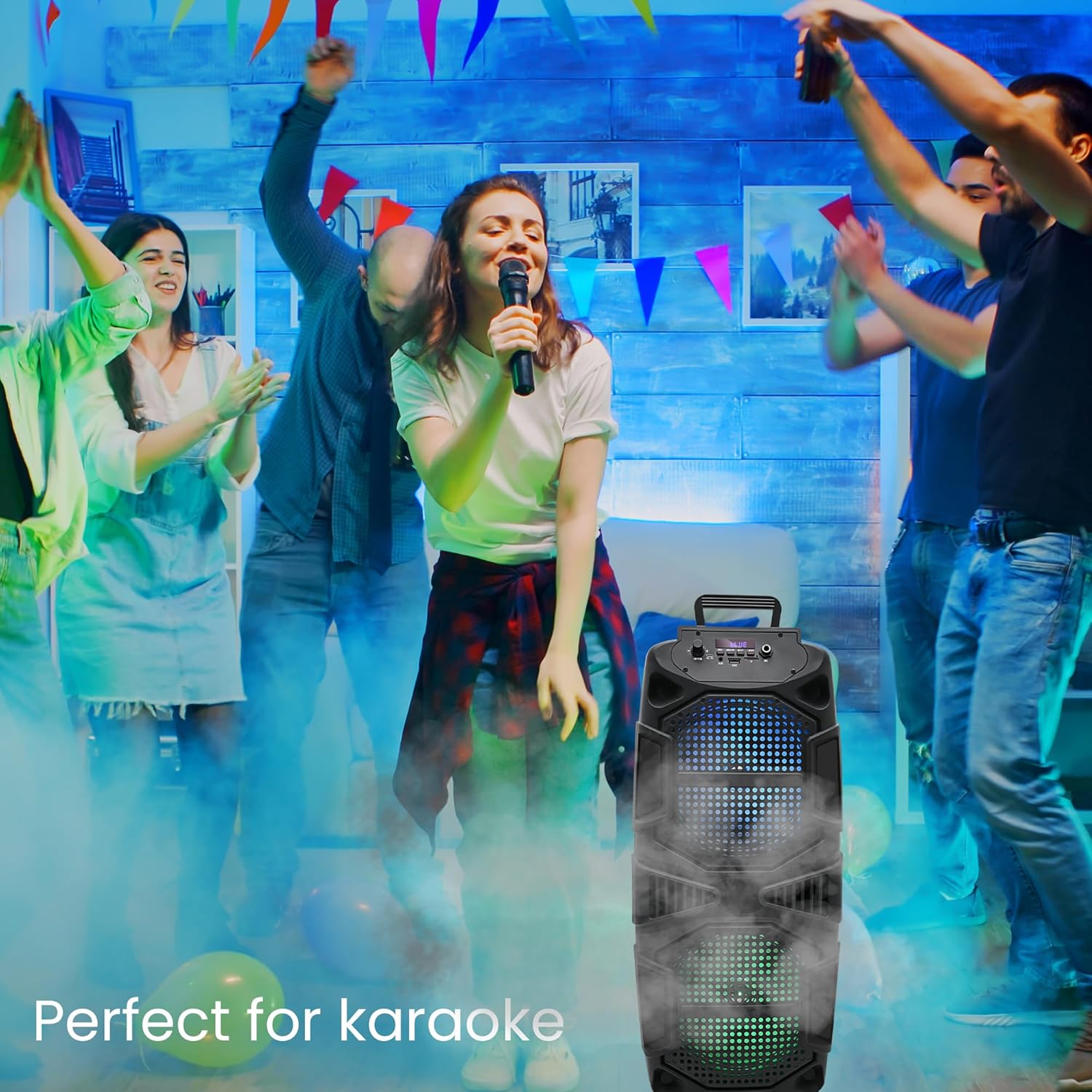 A person singing into a microphone with the Technical Pro TPSPARK28-2 speaker in the foreground, surrounded by a party atmosphere, illustrating its use for karaoke.
