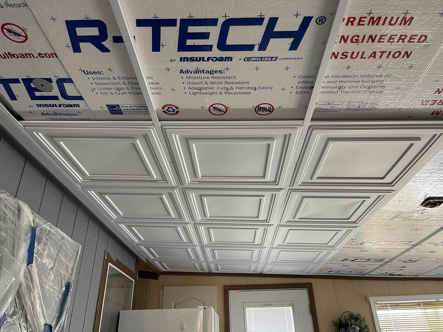 Finished ceiling with installed grid and tiles