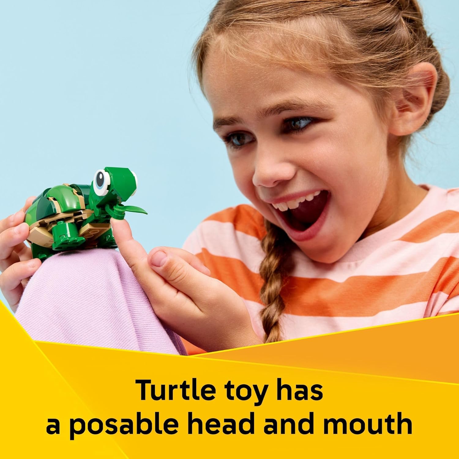 Child interacting with the posable LEGO turtle toy