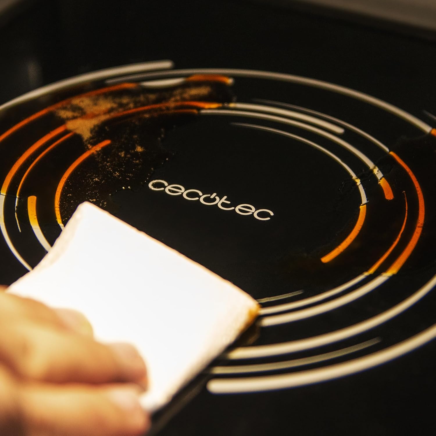 Hand wiping the flatbed interior of the microwave